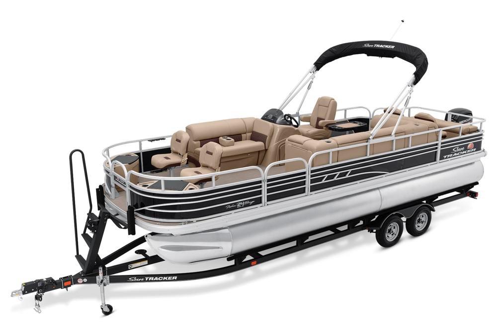 2021 Sun Tracker Fishin' Barge 24 DLX pontoon boat on trailer, featuring spacious seating.