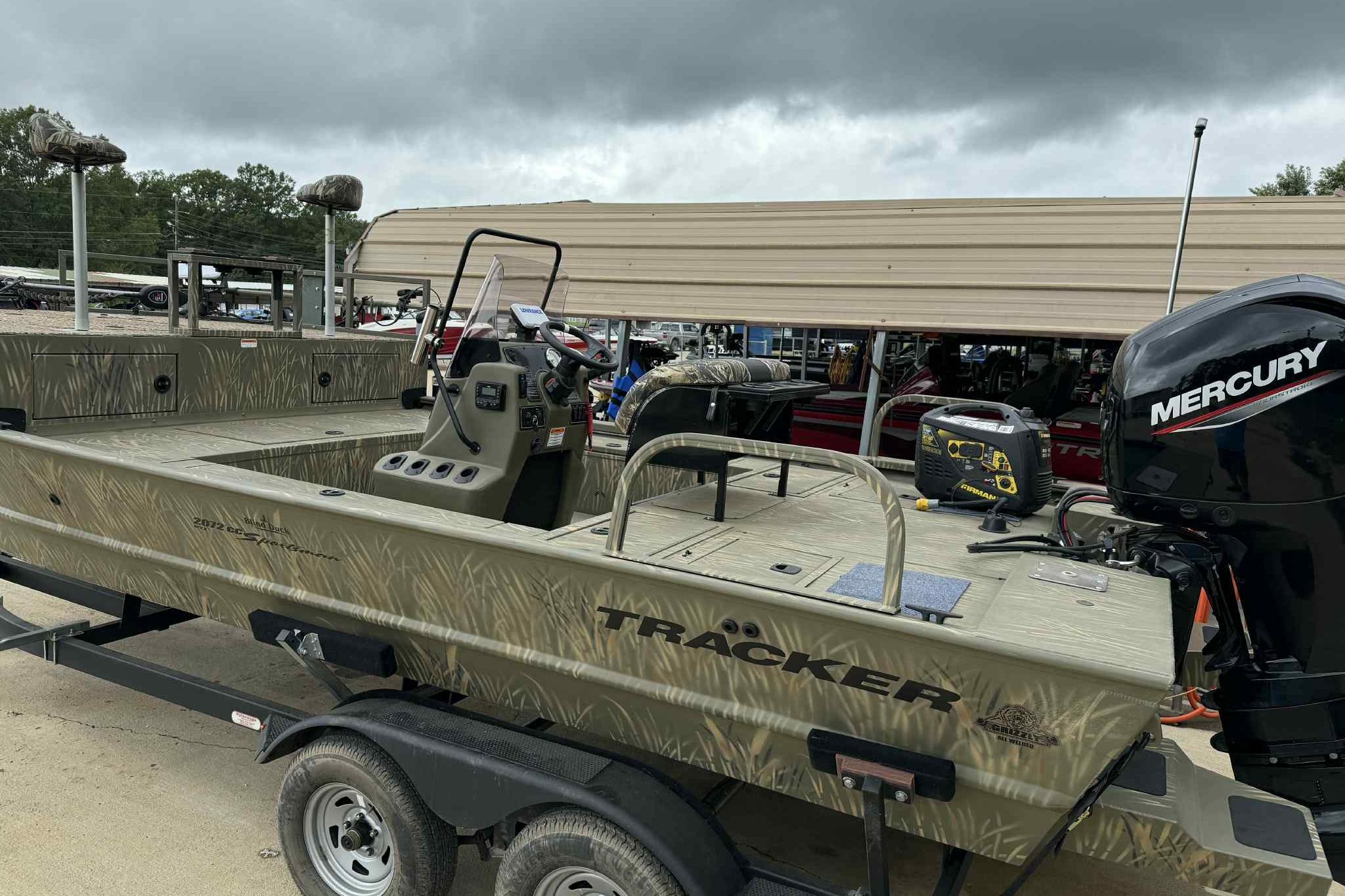 2022 Tracker Grizzly 2072 CC Sportsman boat with Mercury engine on trailer.
