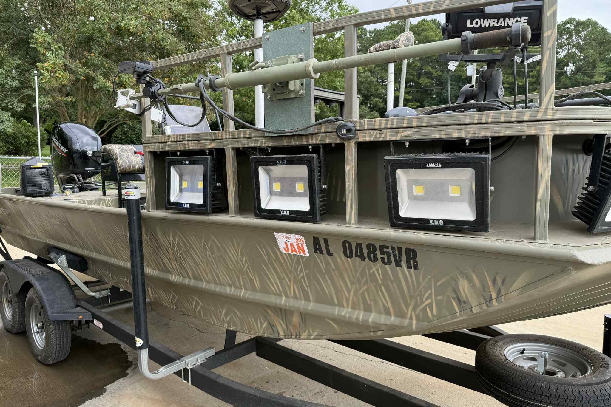 2022 Tracker Grizzly 2072 CC Sportsman boat with LED lights on a trailer.