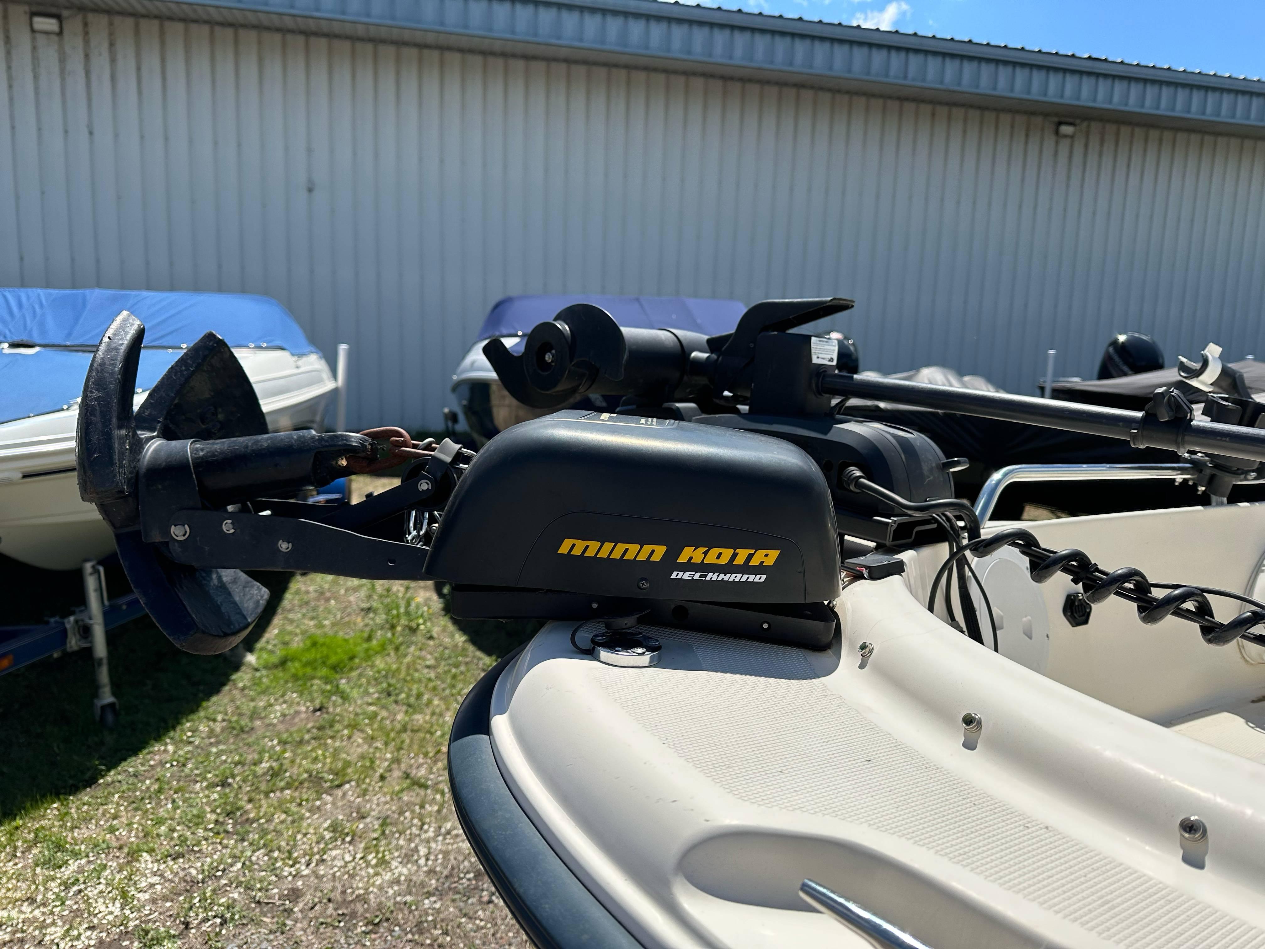 Minn Kota trolling motor on 2003 Sea Hunt Escape 186 boat, parked outdoors.