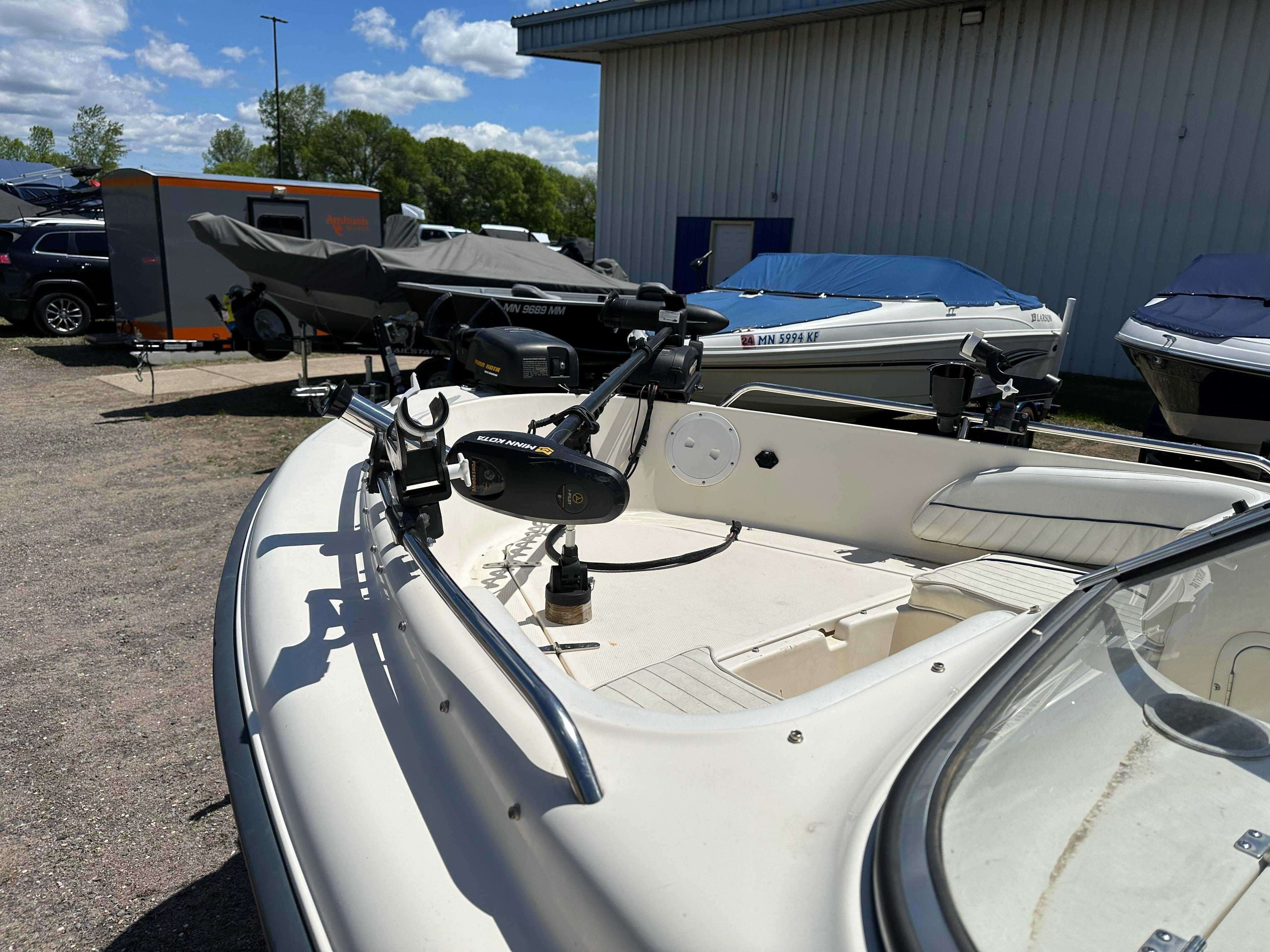 2003 Sea Hunt Escape 186 boat parked outdoors, featuring a trolling motor and clear skies.