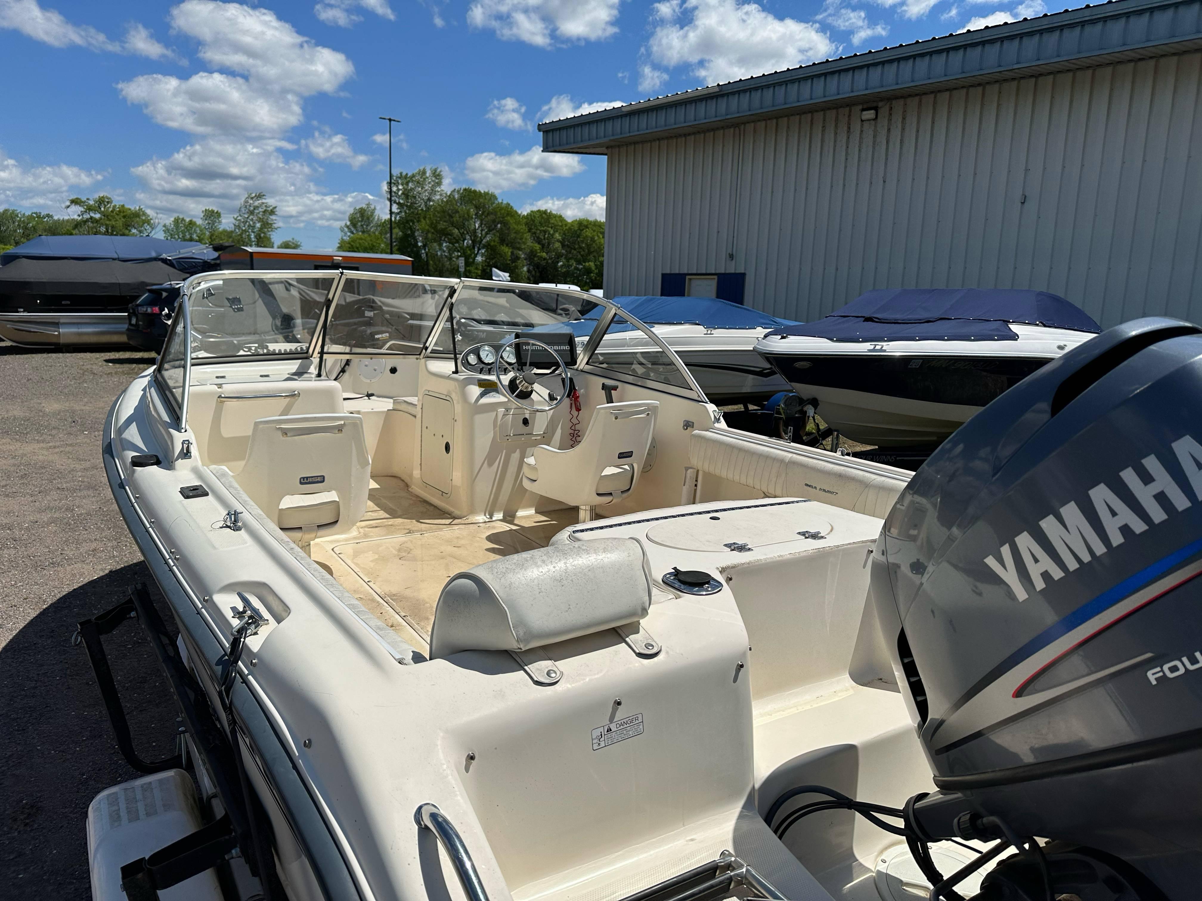 2003 Sea Hunt Escape 186 boat with Yamaha outboard motor, parked outdoors.