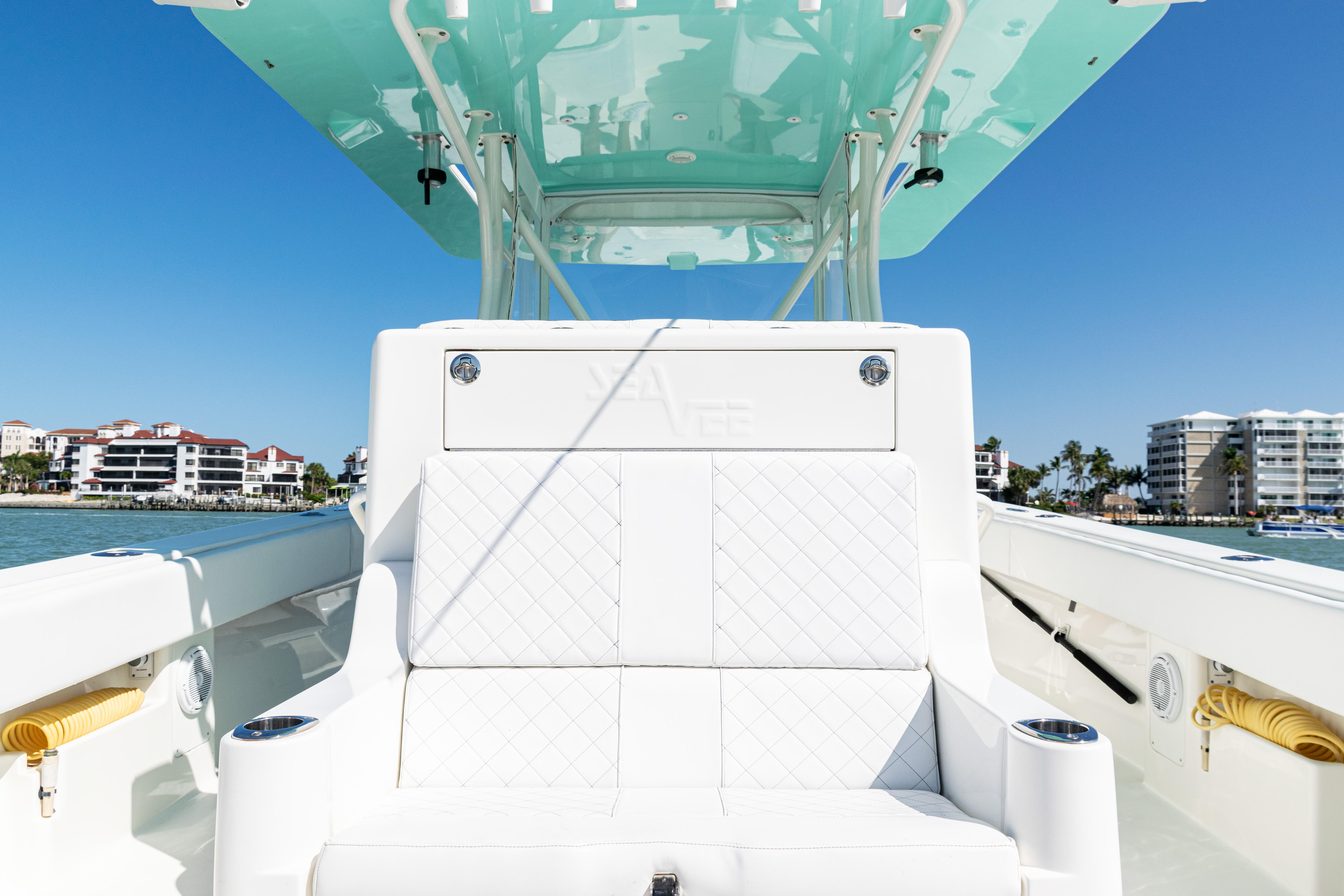 SeaVee-390Z 2015 -FL-US-2015 SeaVee 390Z boat interior with white seating and turquoise canopy, docked near waterfront buildings.-9766060 | Thumbnail