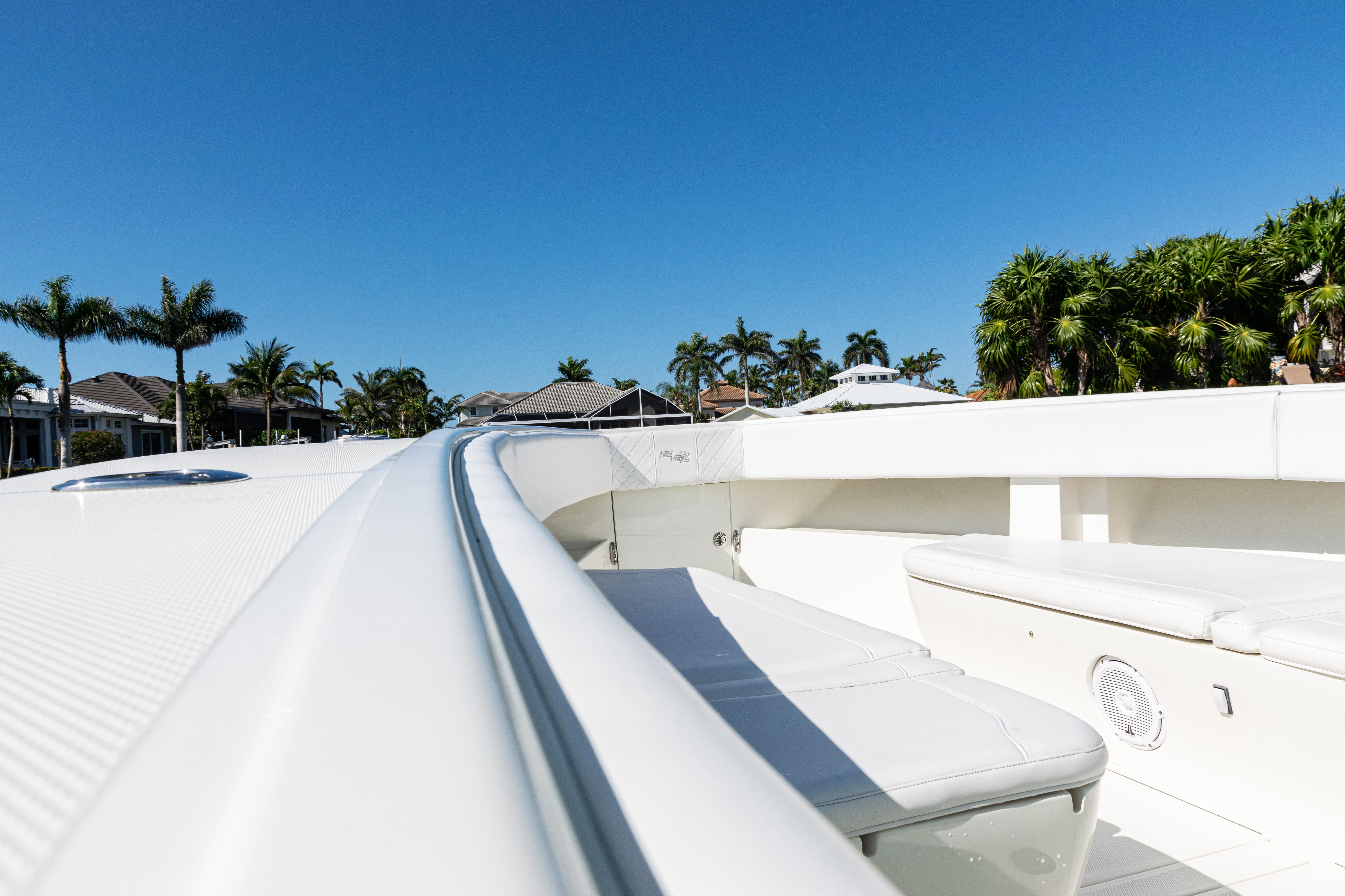 SeaVee-390Z 2015 -FL-US-2015 SeaVee 390Z boat deck with seating, surrounded by palm trees and clear blue sky.-9766060 | Thumbnail