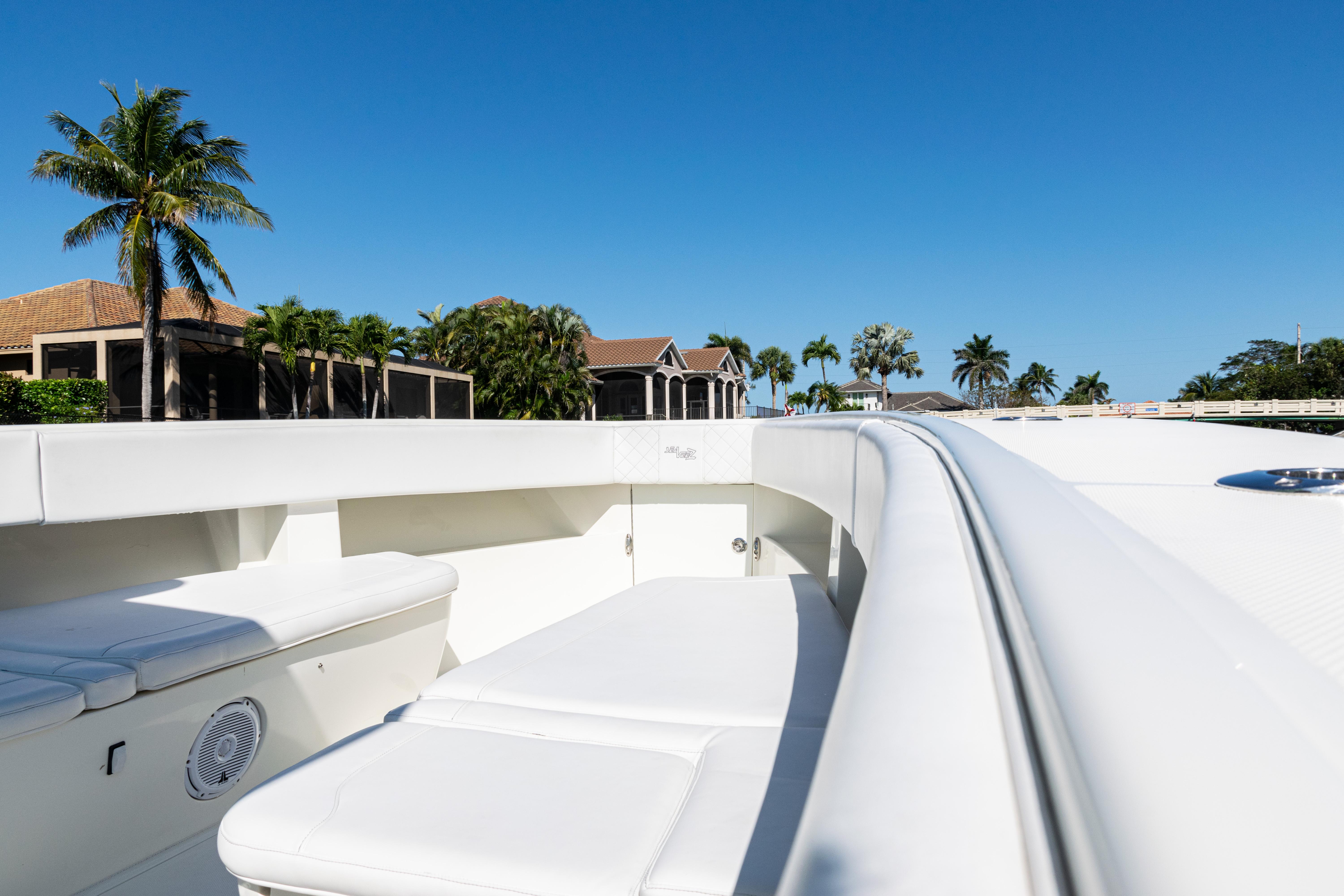 SeaVee-390Z 2015 -FL-US-2015 SeaVee 390Z boat deck with seating, set against a clear blue sky and palm trees.-9766060 | Thumbnail