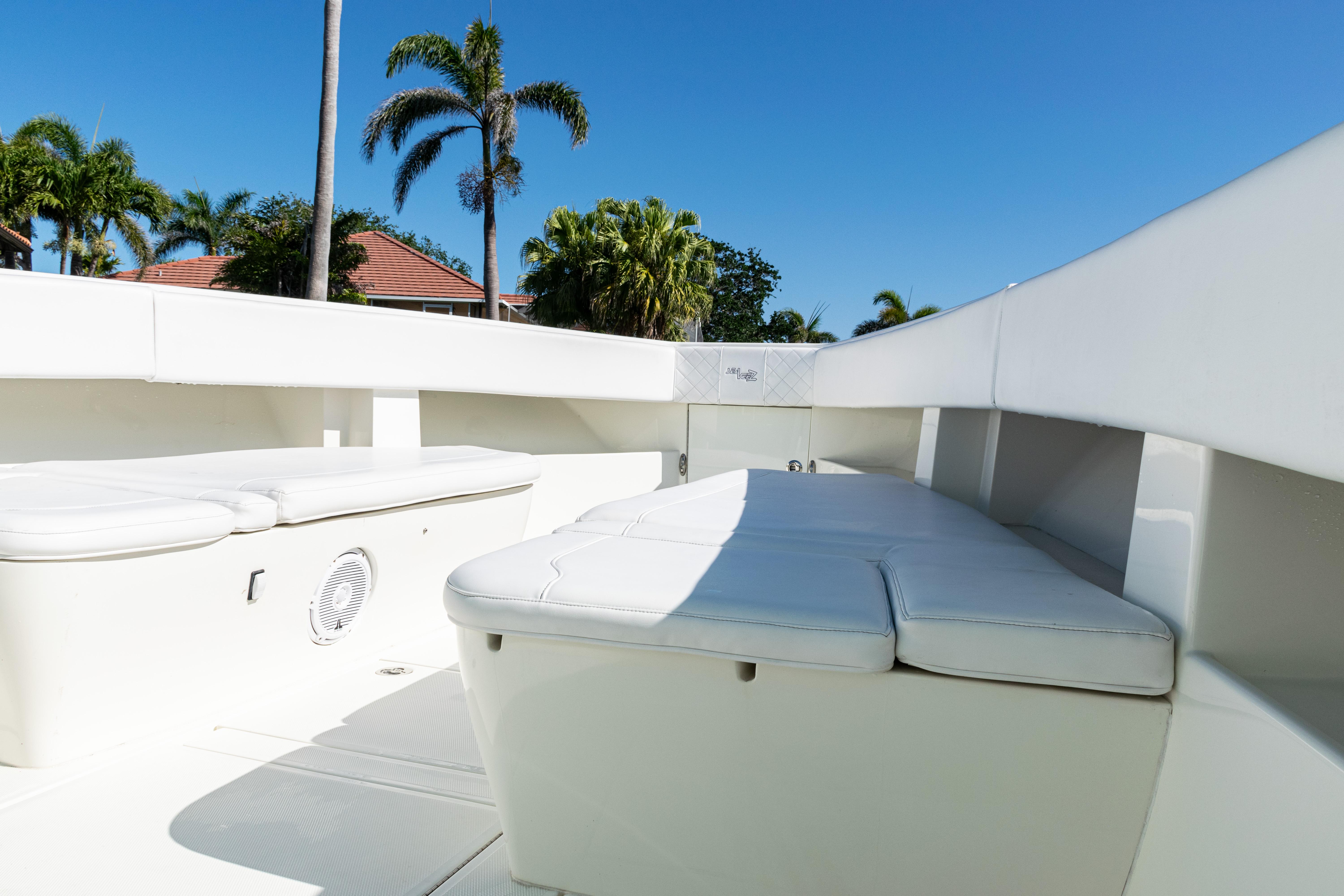 SeaVee-390Z 2015 -FL-US-2015 SeaVee 390Z boat interior with white seating, palm trees, and clear blue sky.-9766060 | Thumbnail