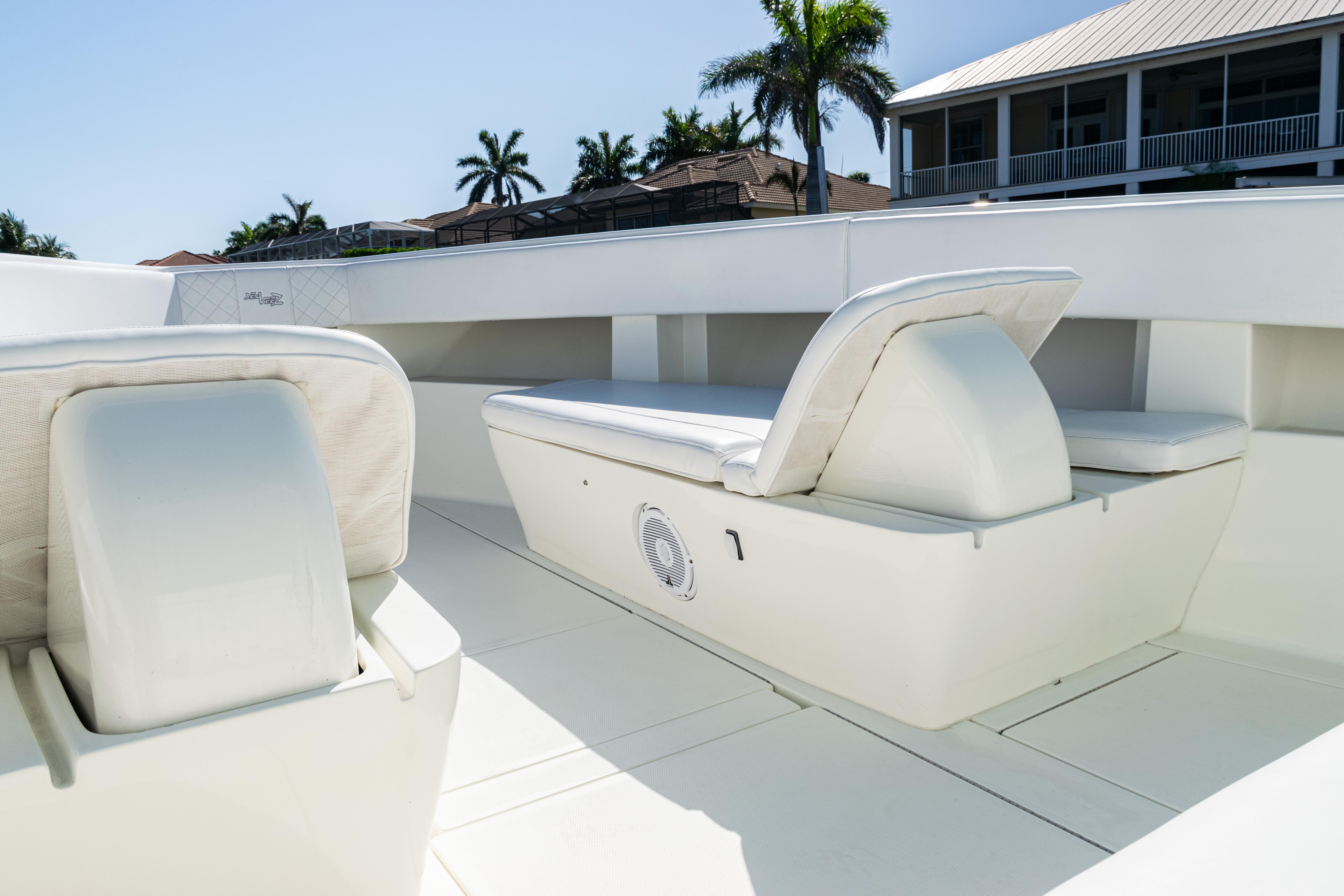 SeaVee-390Z 2015 -FL-US-2015 SeaVee 390Z boat interior with white seating and palm trees in the background.-9766060 | Thumbnail