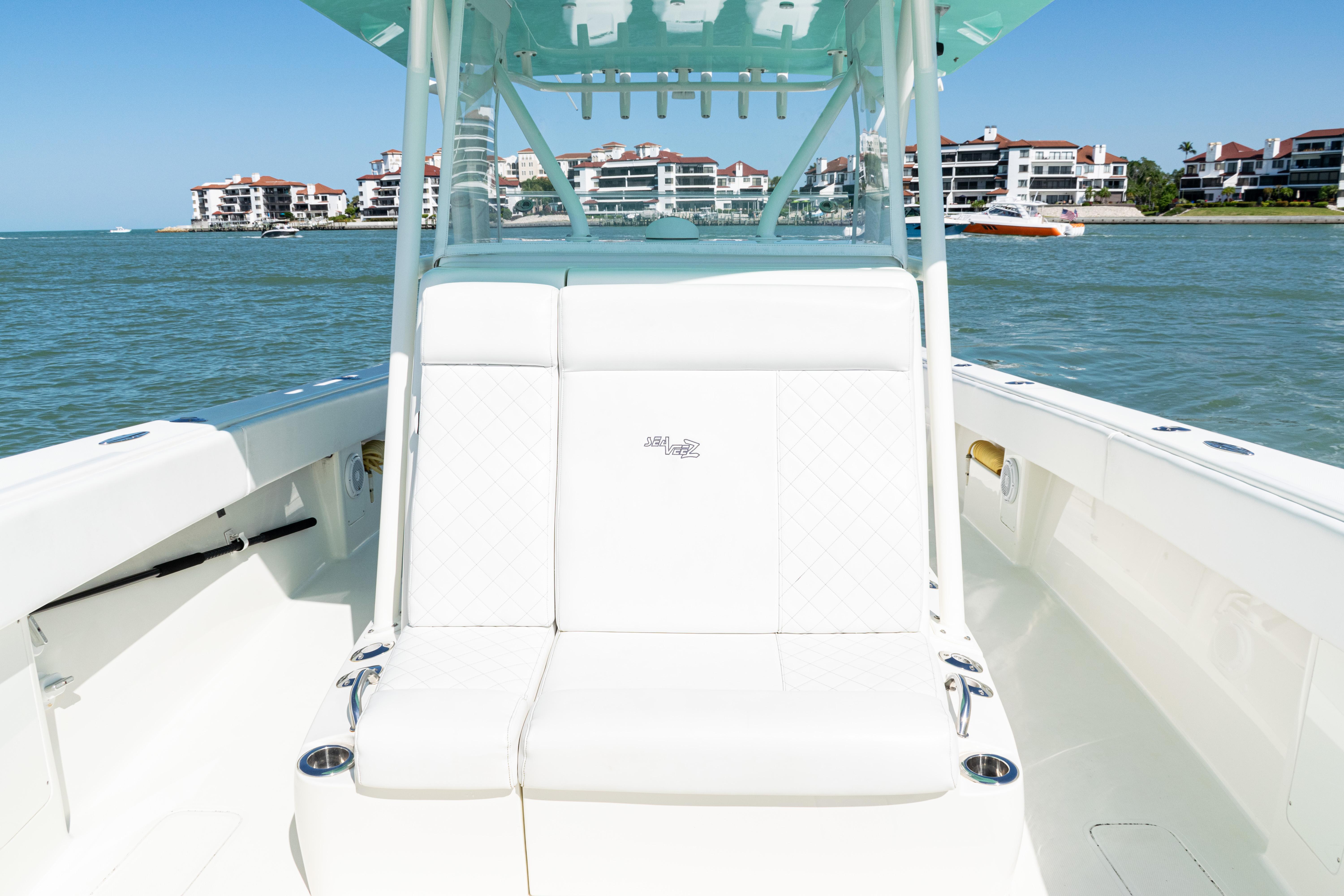 SeaVee-390Z 2015 -FL-US-2015 SeaVee 390Z boat interior with white seating, ocean view, and coastal buildings.-9766060 | Thumbnail