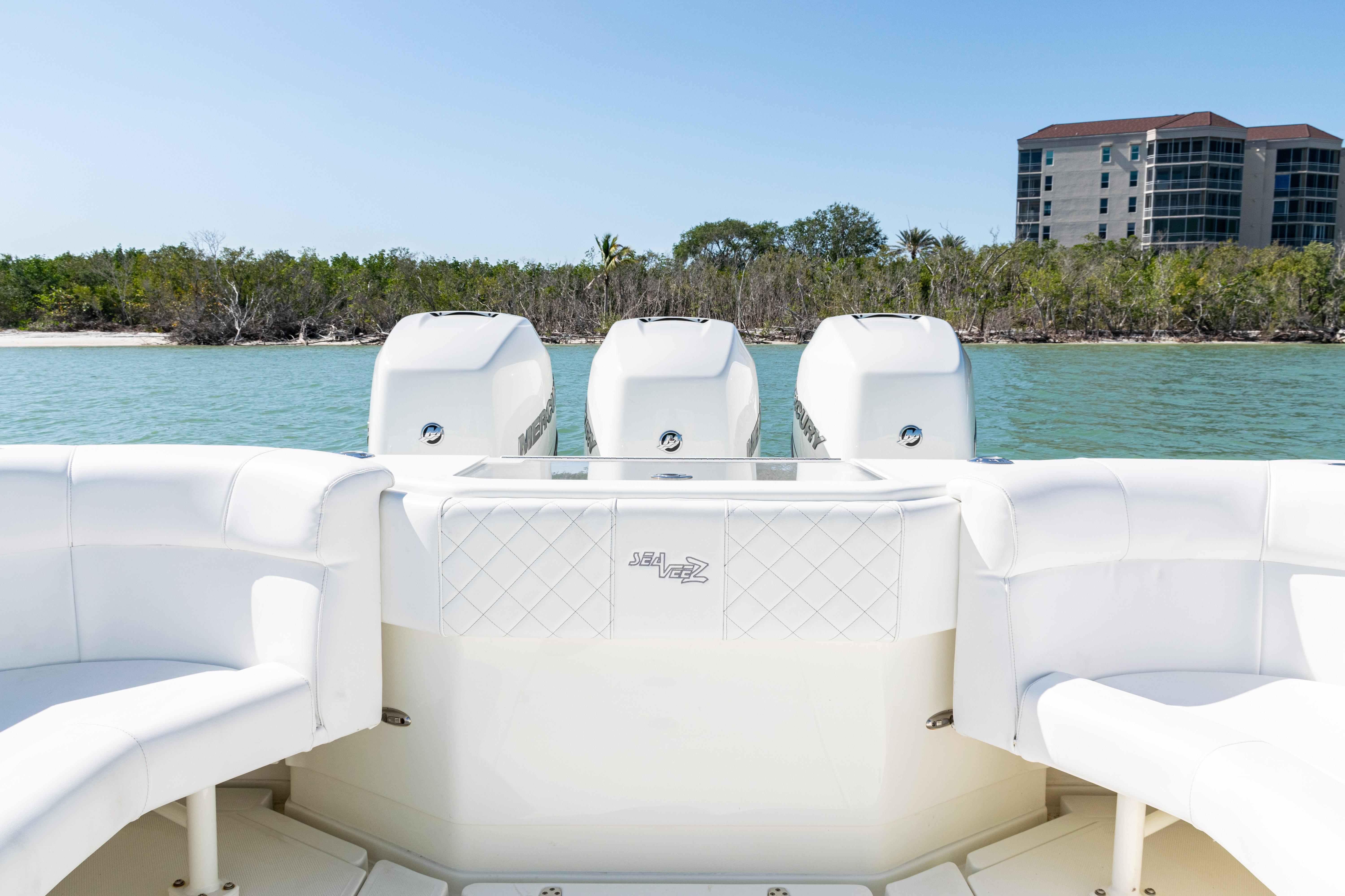 SeaVee-390Z 2015 -FL-US-2015 SeaVee 390Z boat with quad engines, white seating, and coastal backdrop.-9766060 | Thumbnail
