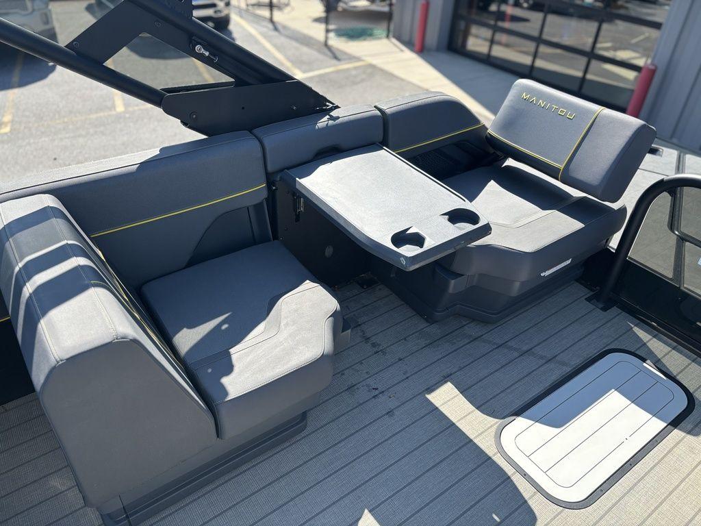 2023 Manitou Explore 22 Max Bench boat interior with gray seating and table.