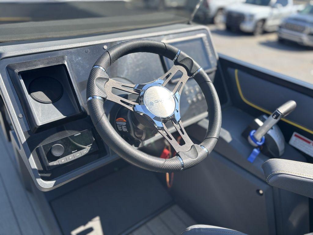 2023 Manitou Explore 22 Max Bench steering wheel and dashboard, featuring modern controls and design.