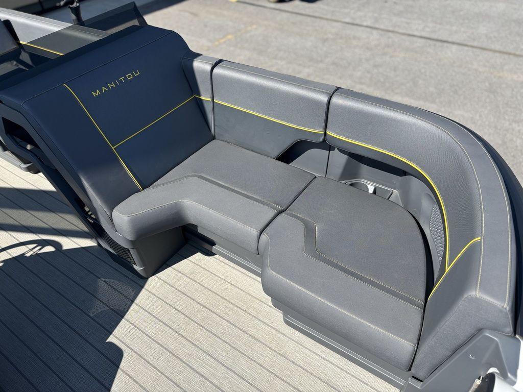 2023 Manitou Explore 22 Max Bench with sleek gray seating and yellow accents.