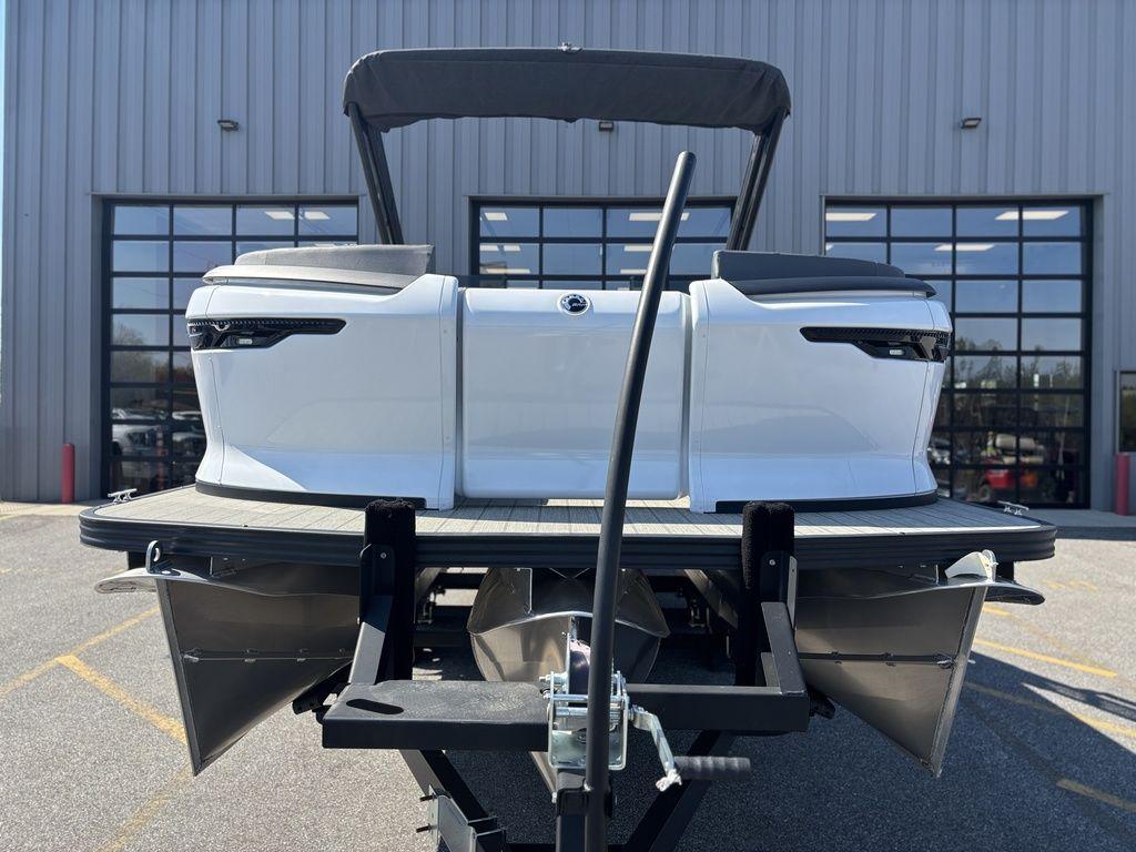 2023 Manitou Explore 22 Max Bench pontoon boat on trailer, rear view.