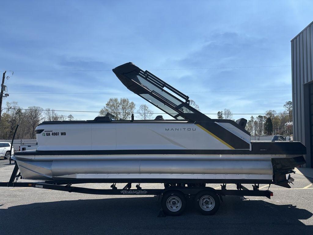 2023 Manitou Explore 22 Max Bench pontoon boat on trailer, side view.