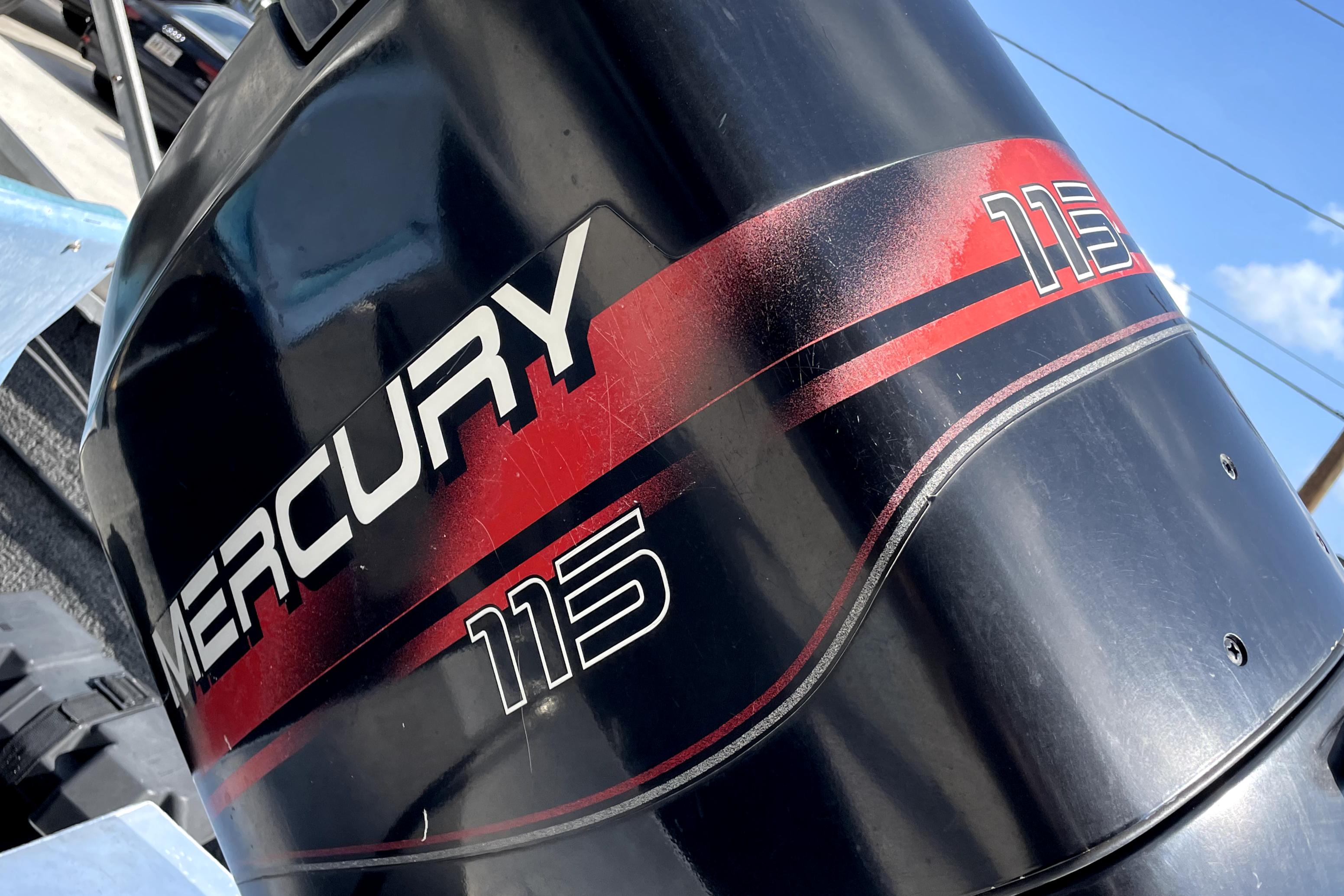Mercury 115 outboard motor on Custom Aluminum 15, 1994 model, with red and black design.