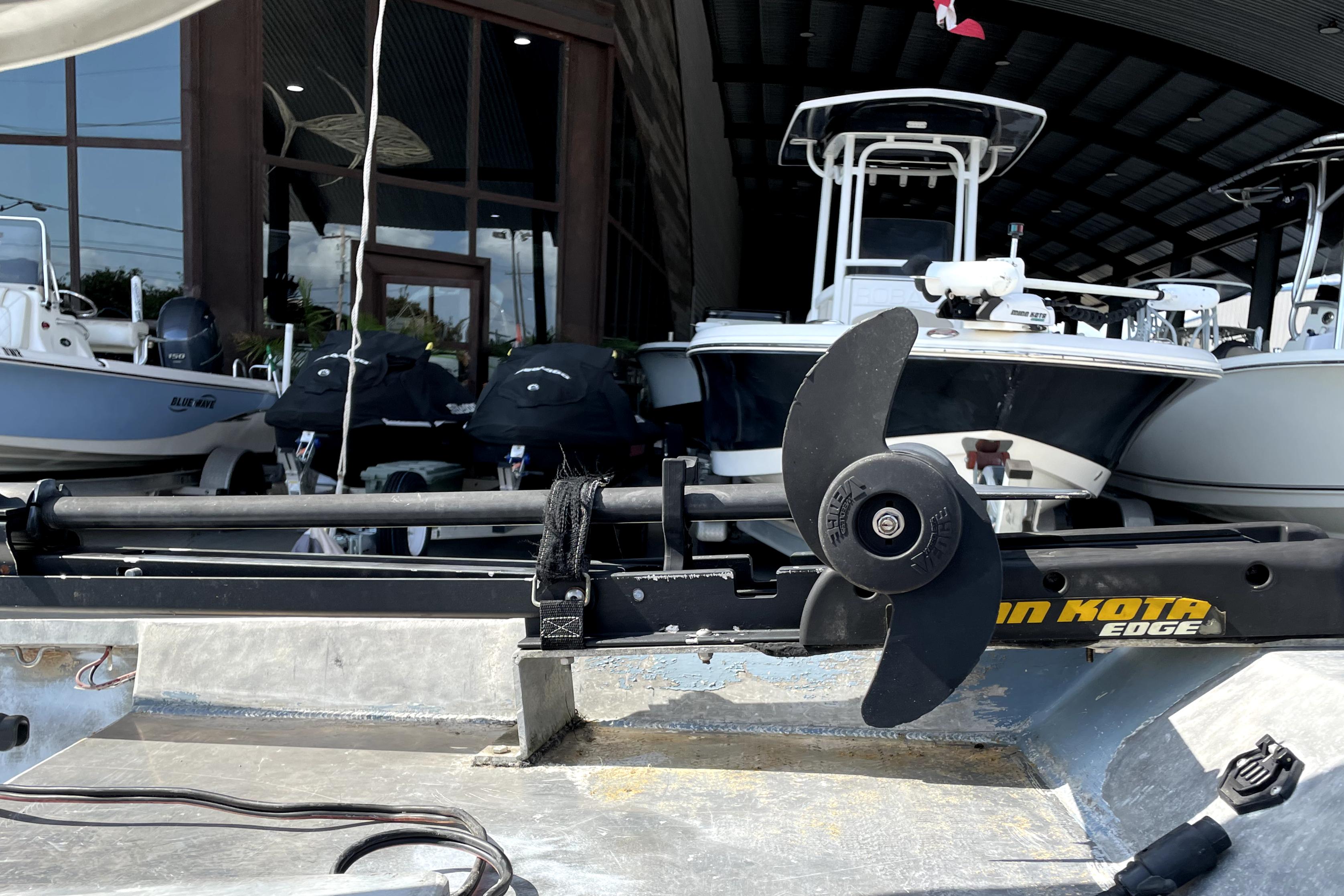 Custom Aluminum 15 boat with Minn Kota Edge trolling motor, docked among other boats.
