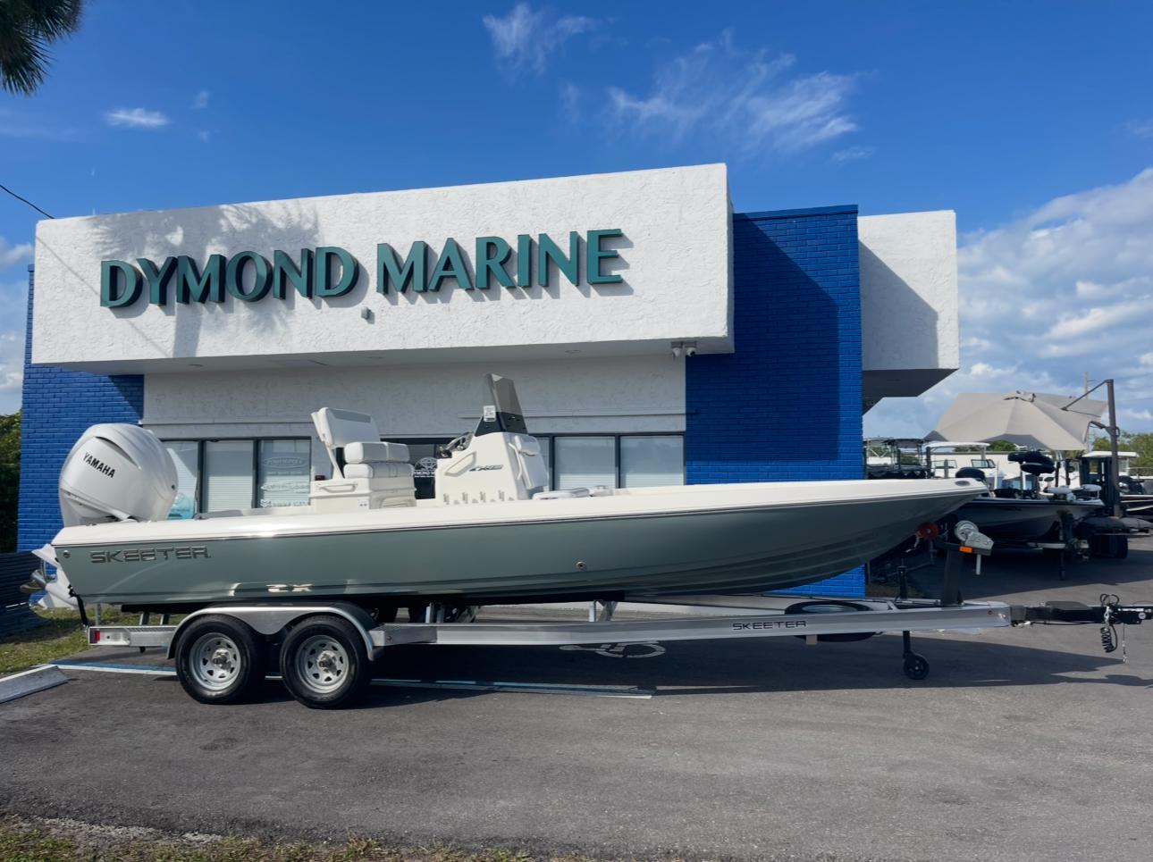 2025 Skeeter SX230 boat on trailer outside Dymond Marine dealership.