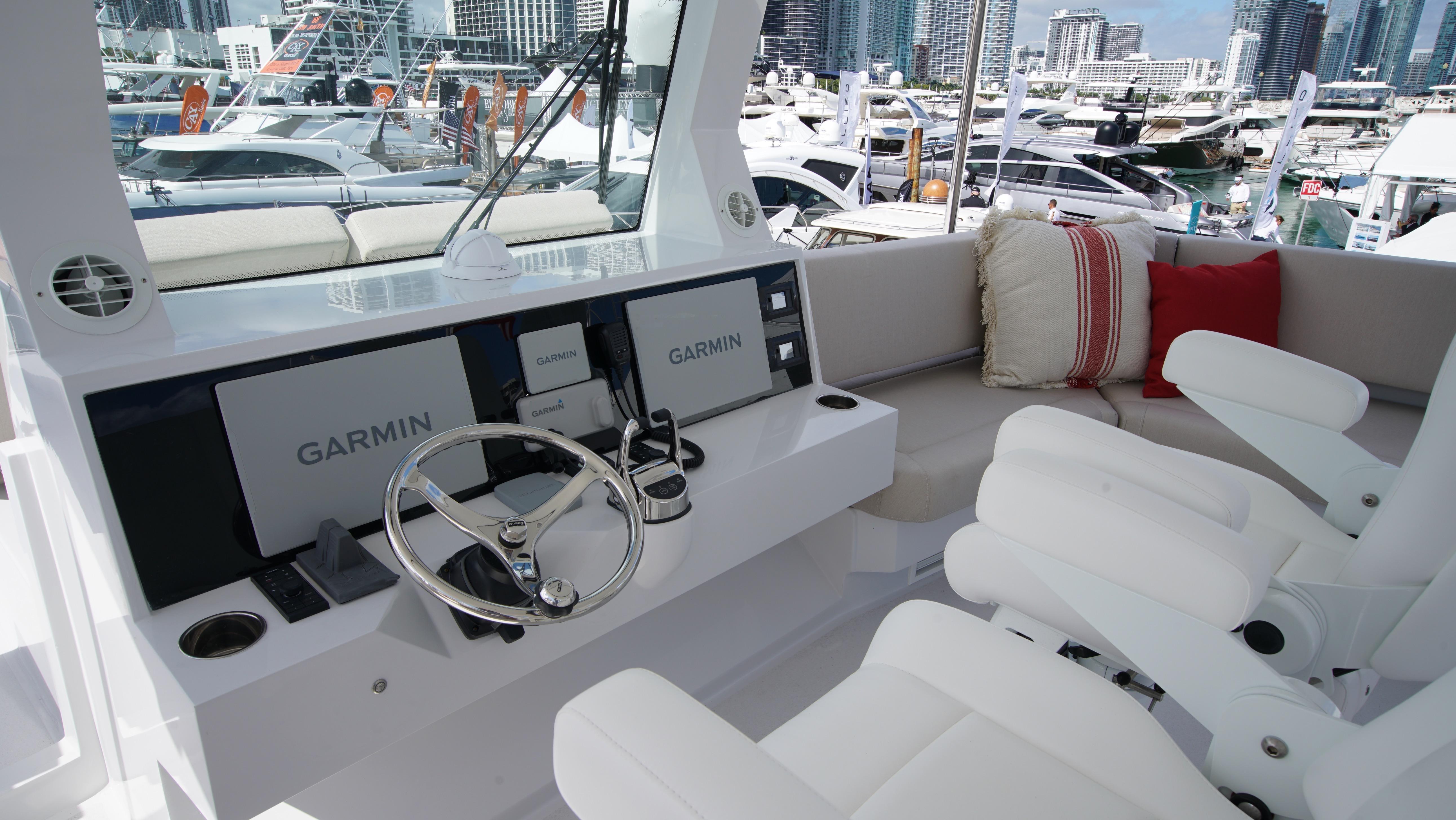Two Oceans-555  008 2025 -FL-US-Luxury yacht cockpit with Garmin navigation, plush seating, and marina view. Two Oceans 555  008, 2025.-9676126 | Thumbnail
