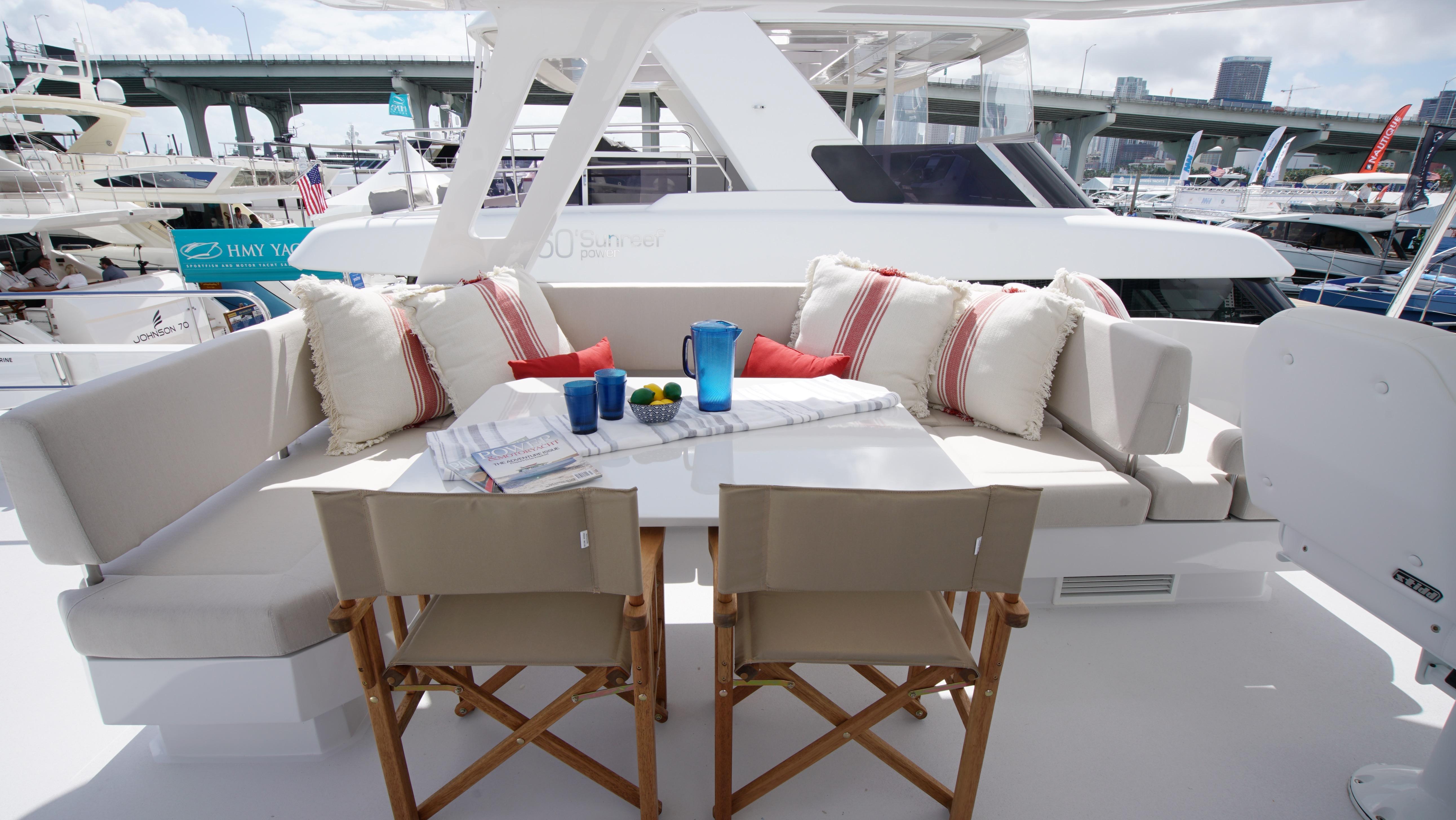 Two Oceans-555  008 2025 -FL-US-Luxury yacht deck with cushioned seating and dining area, Two Oceans 555  008, 2025 model.-9676126 | Thumbnail