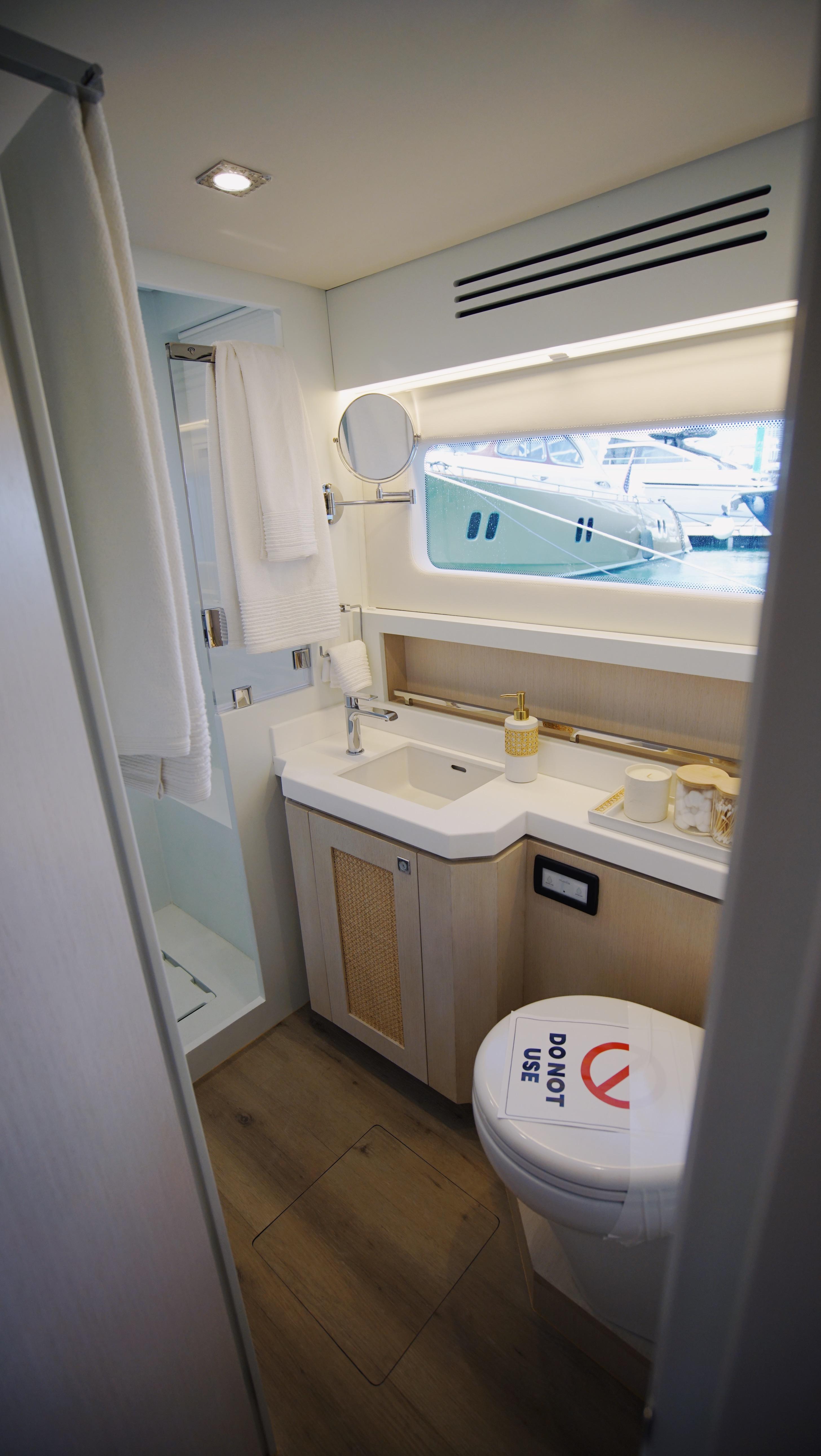 Two Oceans-555  008 2025 -FL-US-Modern yacht bathroom with sleek design, featuring a shower, sink, and toilet. Two Oceans 555  008.-9676126 | Thumbnail