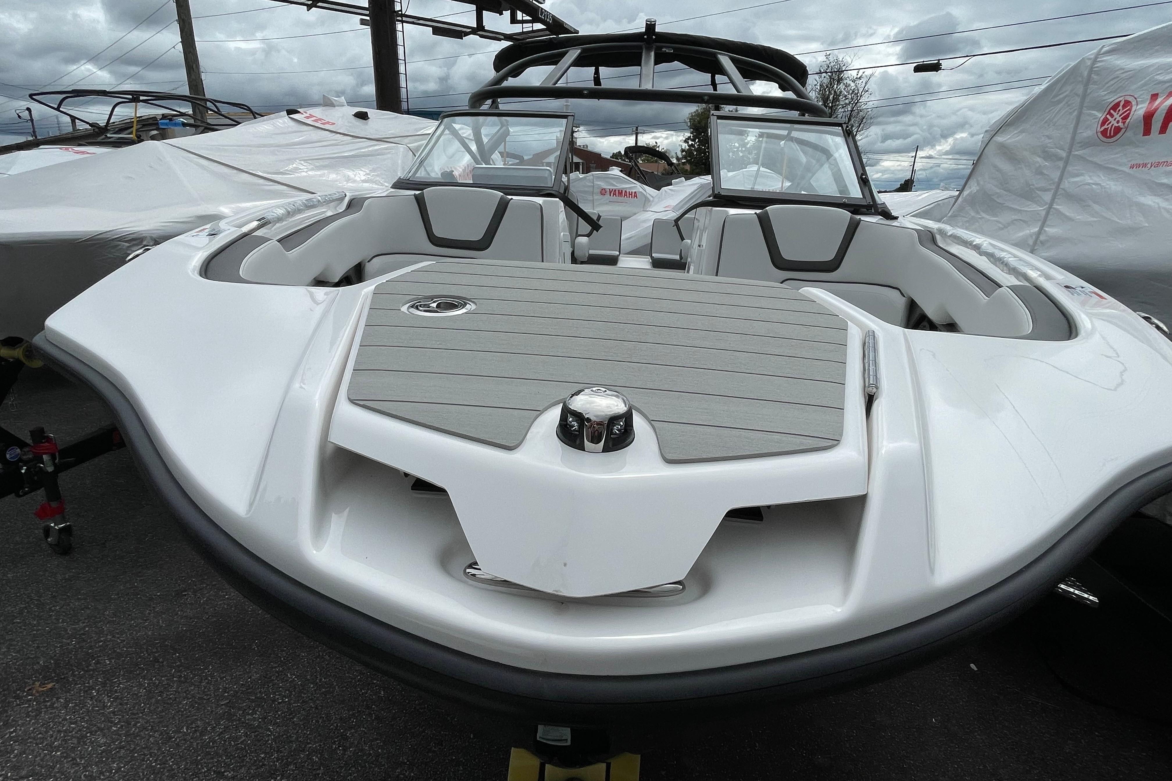 2026 Yamaha AR250 boat with sleek design, parked outdoors under cloudy skies.