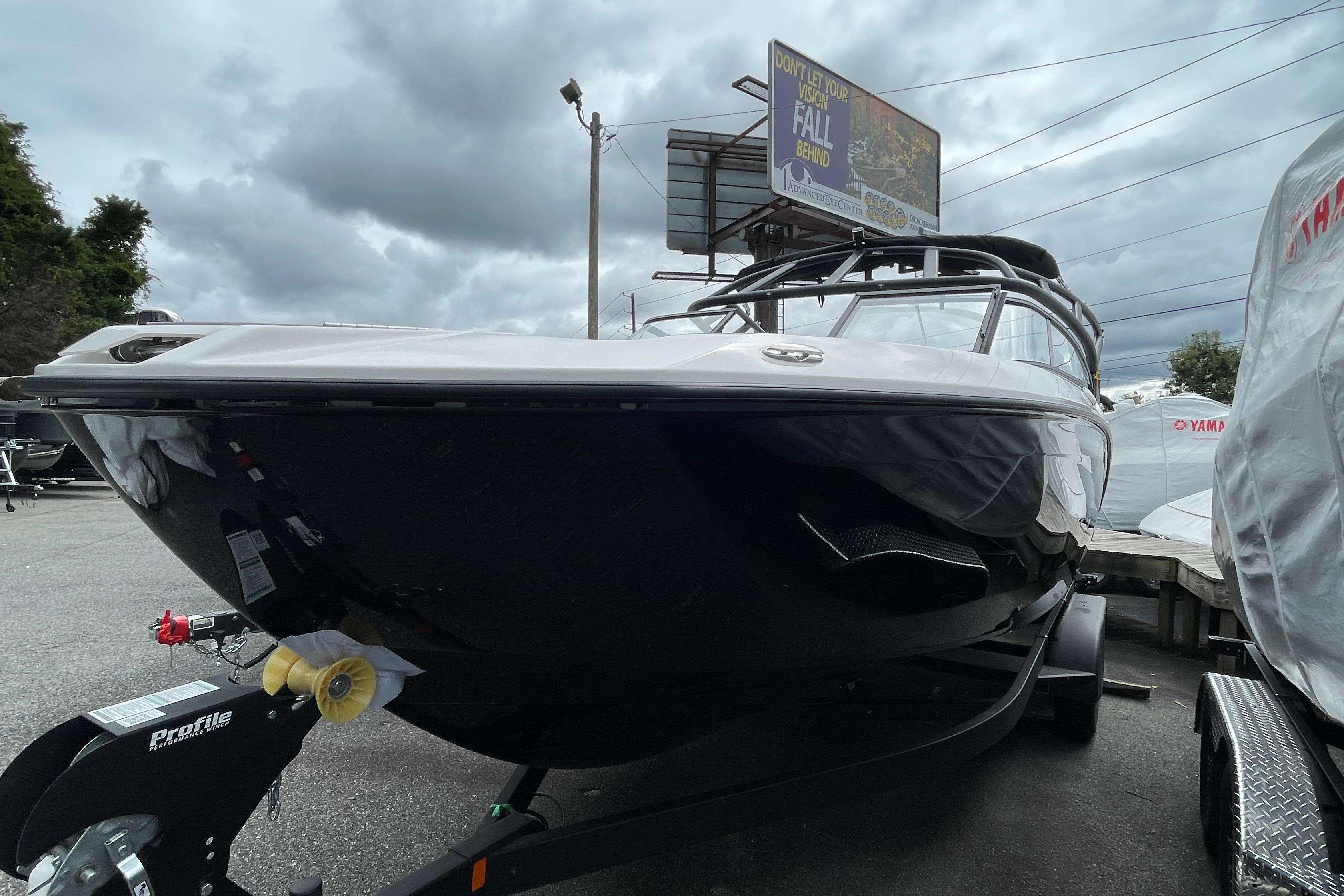2026 Yamaha AR250 boat on trailer under cloudy sky.