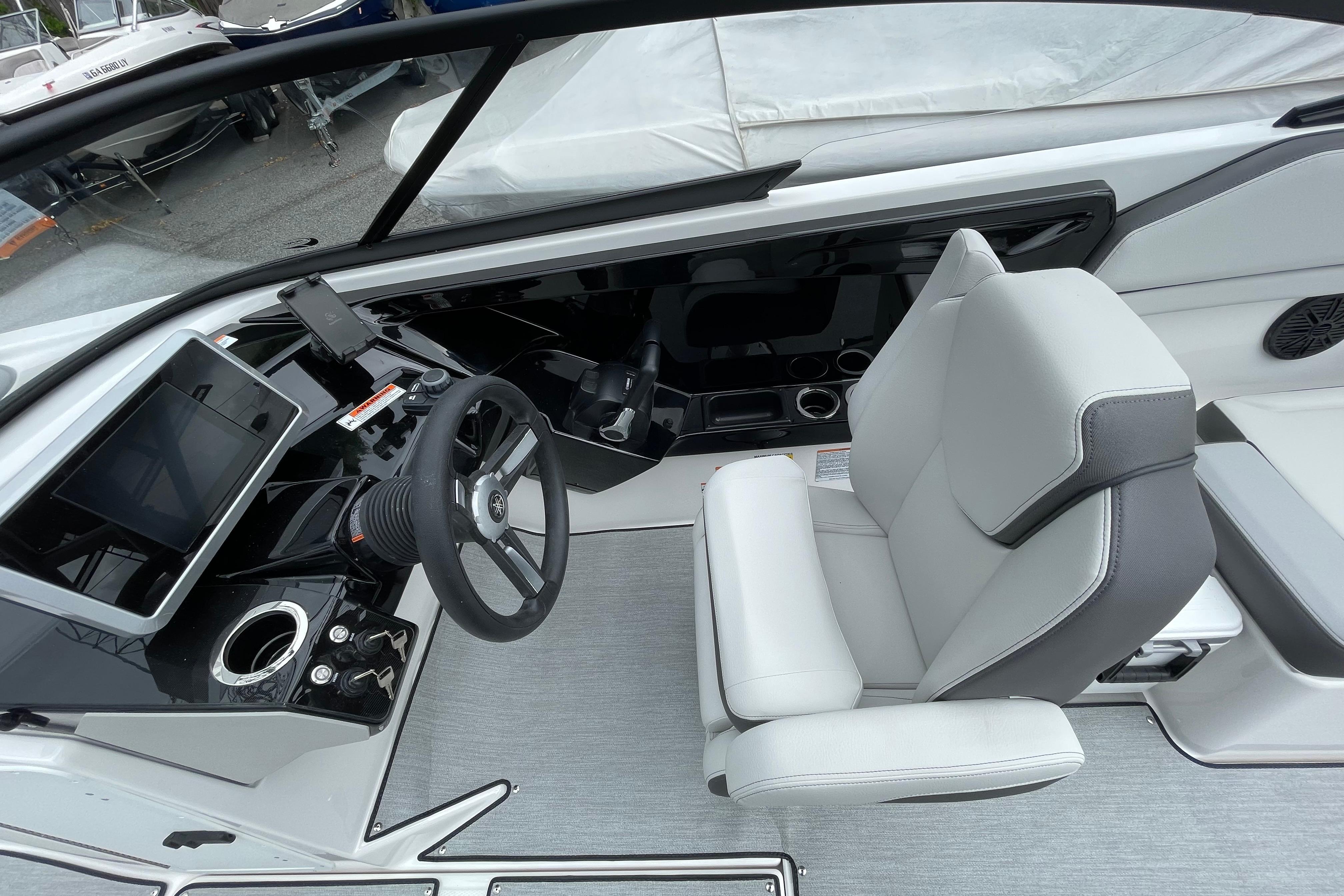 2026 Yamaha AR250 boat cockpit with modern steering and comfortable seating.