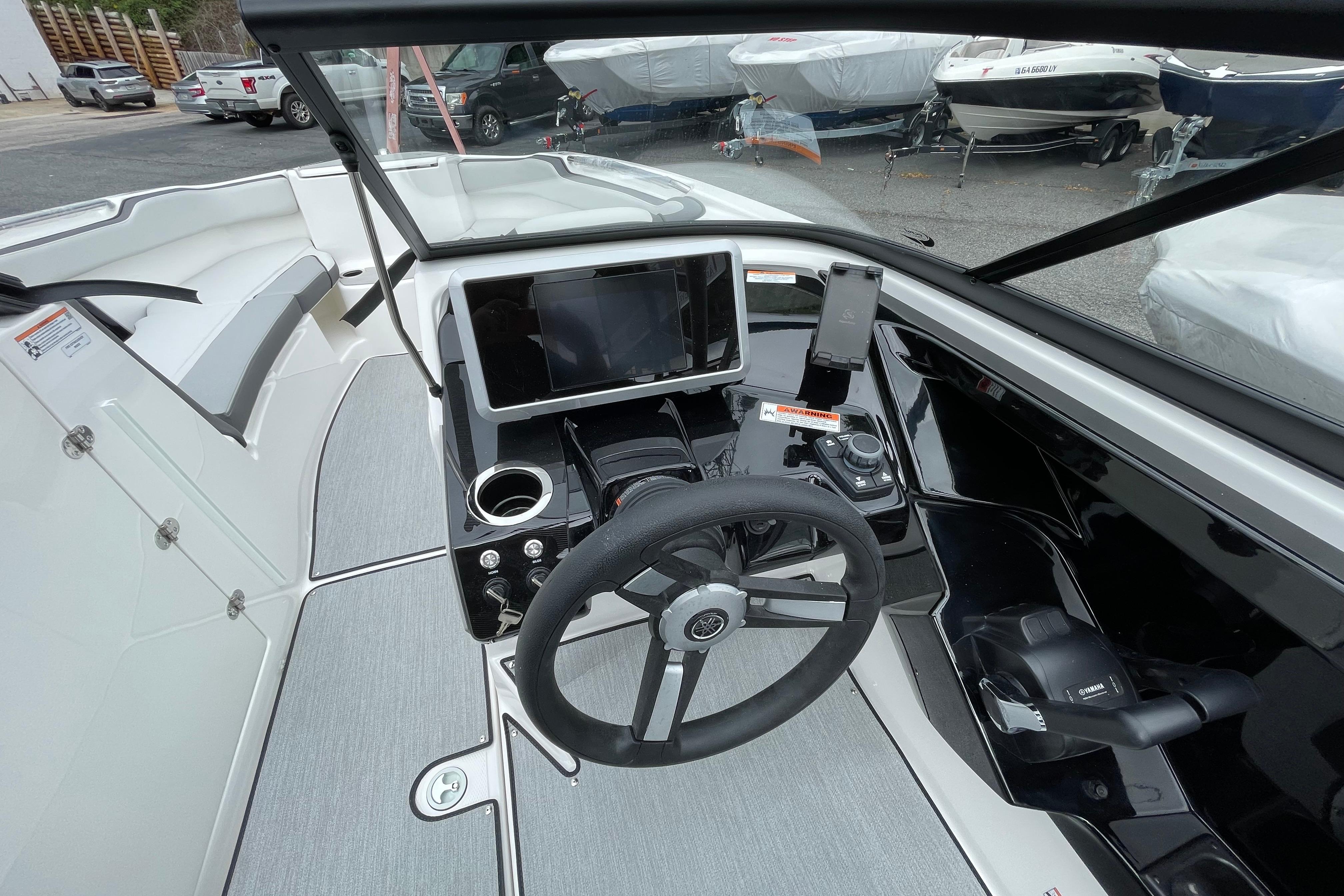 2026 Yamaha AR250 boat cockpit with steering wheel, touchscreen, and controls.