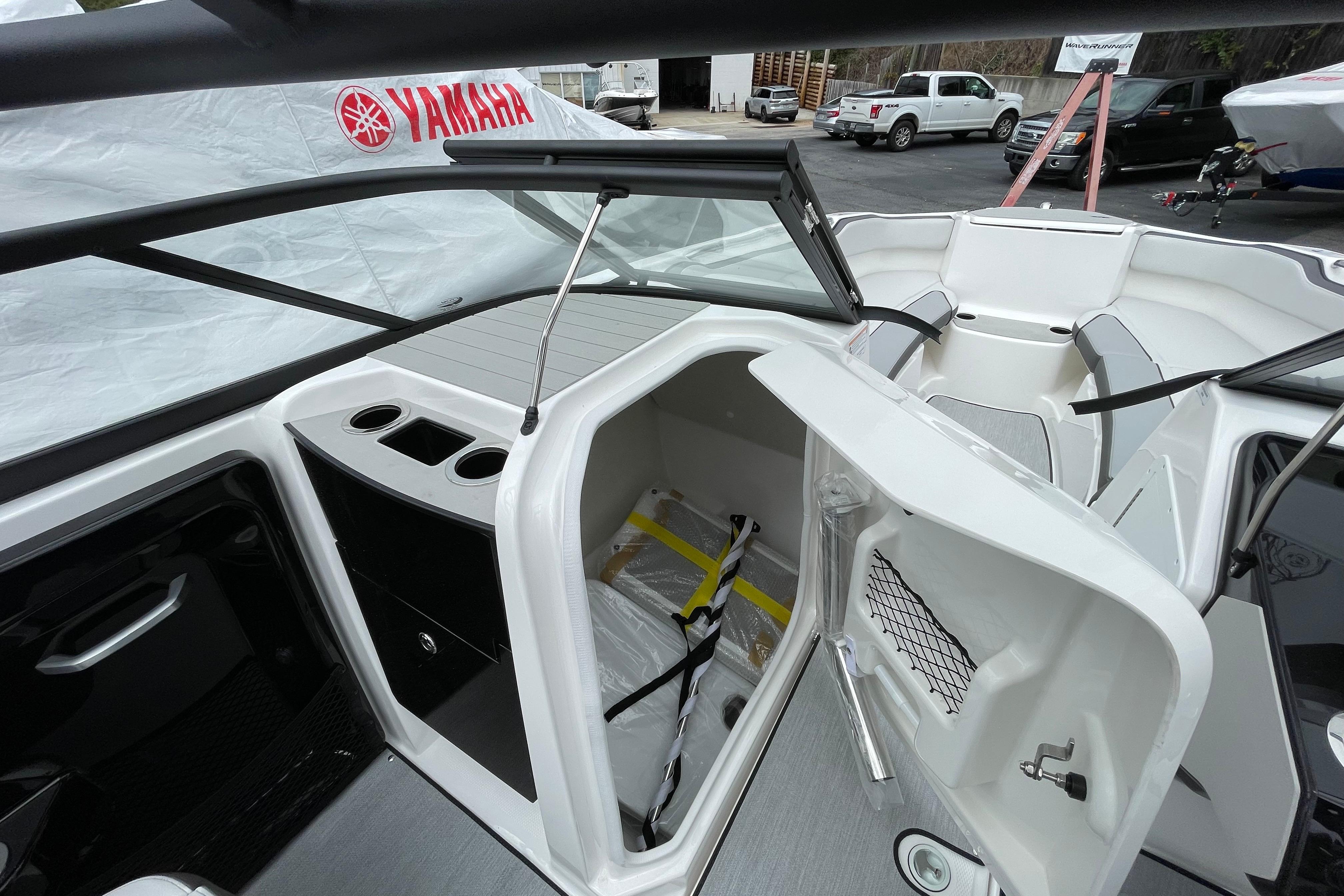 2026 Yamaha AR250 boat interior with storage compartment and seating area.