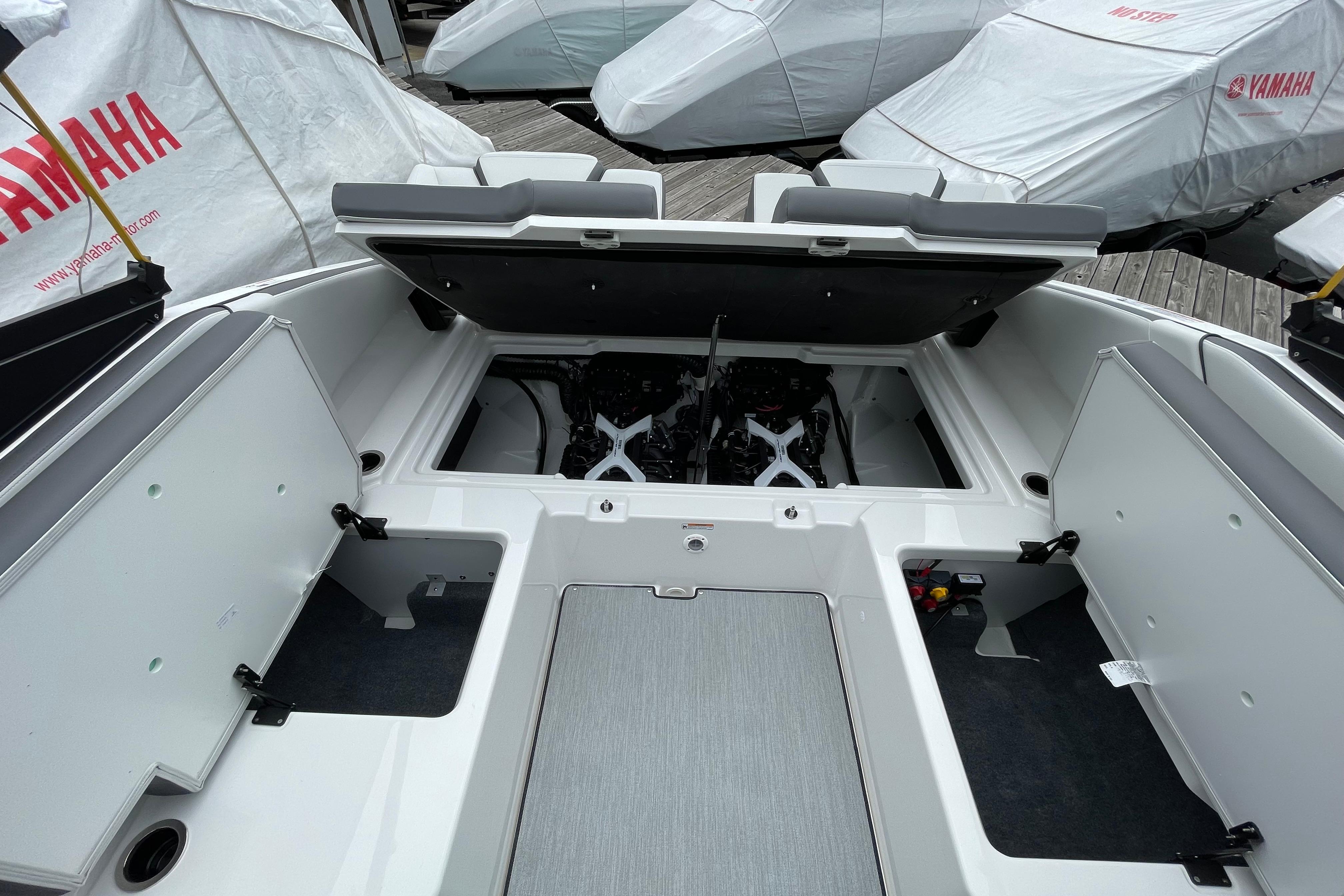 2026 Yamaha AR250 boat interior with open storage compartments and engine view.