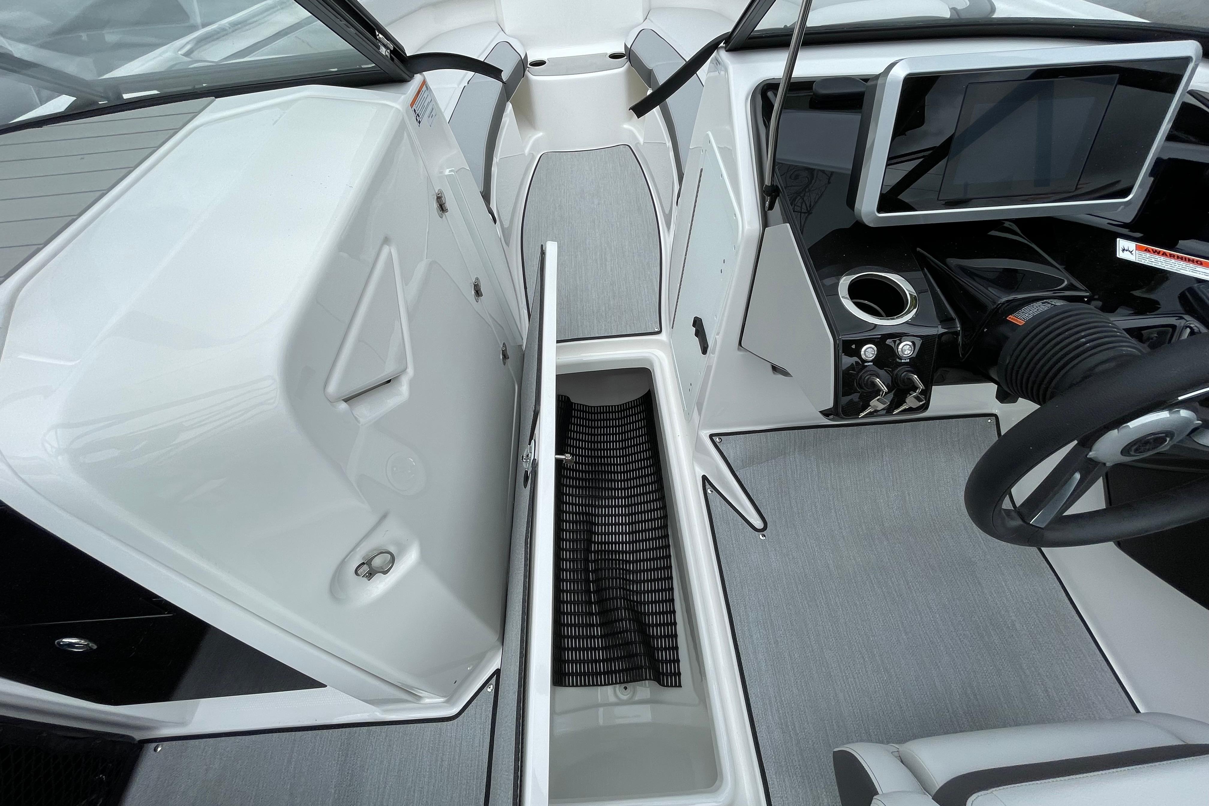 2026 Yamaha AR250 boat interior with storage compartment and modern dashboard.
