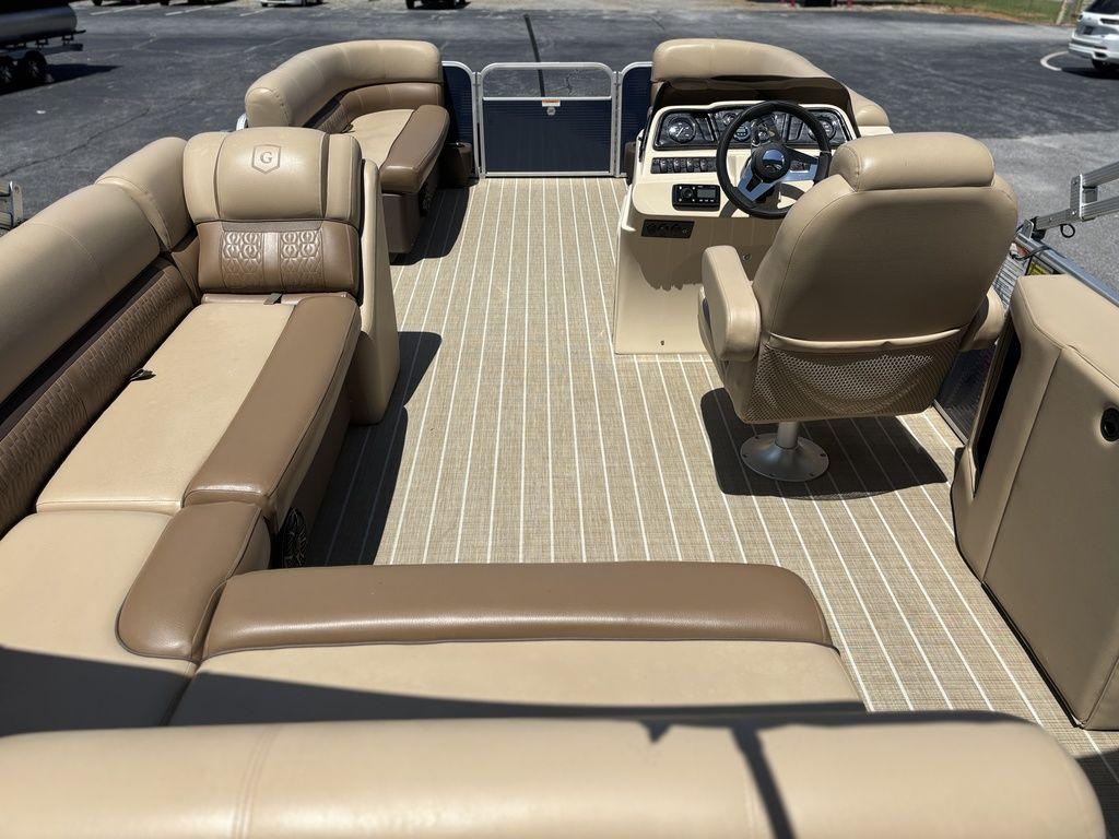 Interior of 2021 Godfrey SW 2086 C pontoon boat with beige seating and steering console.