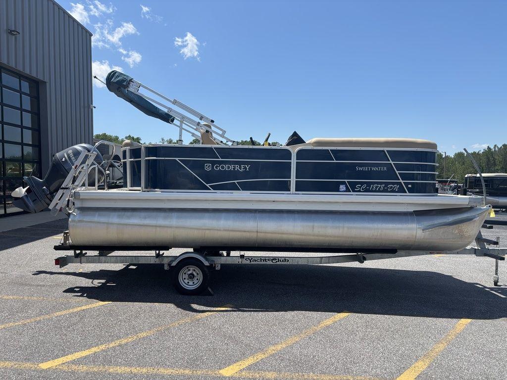 2021 Godfrey SW 2086 C pontoon boat on trailer, parked outdoors.