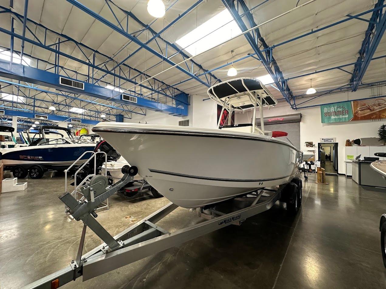 2025 Mako 214 CC boat displayed indoors on a trailer.