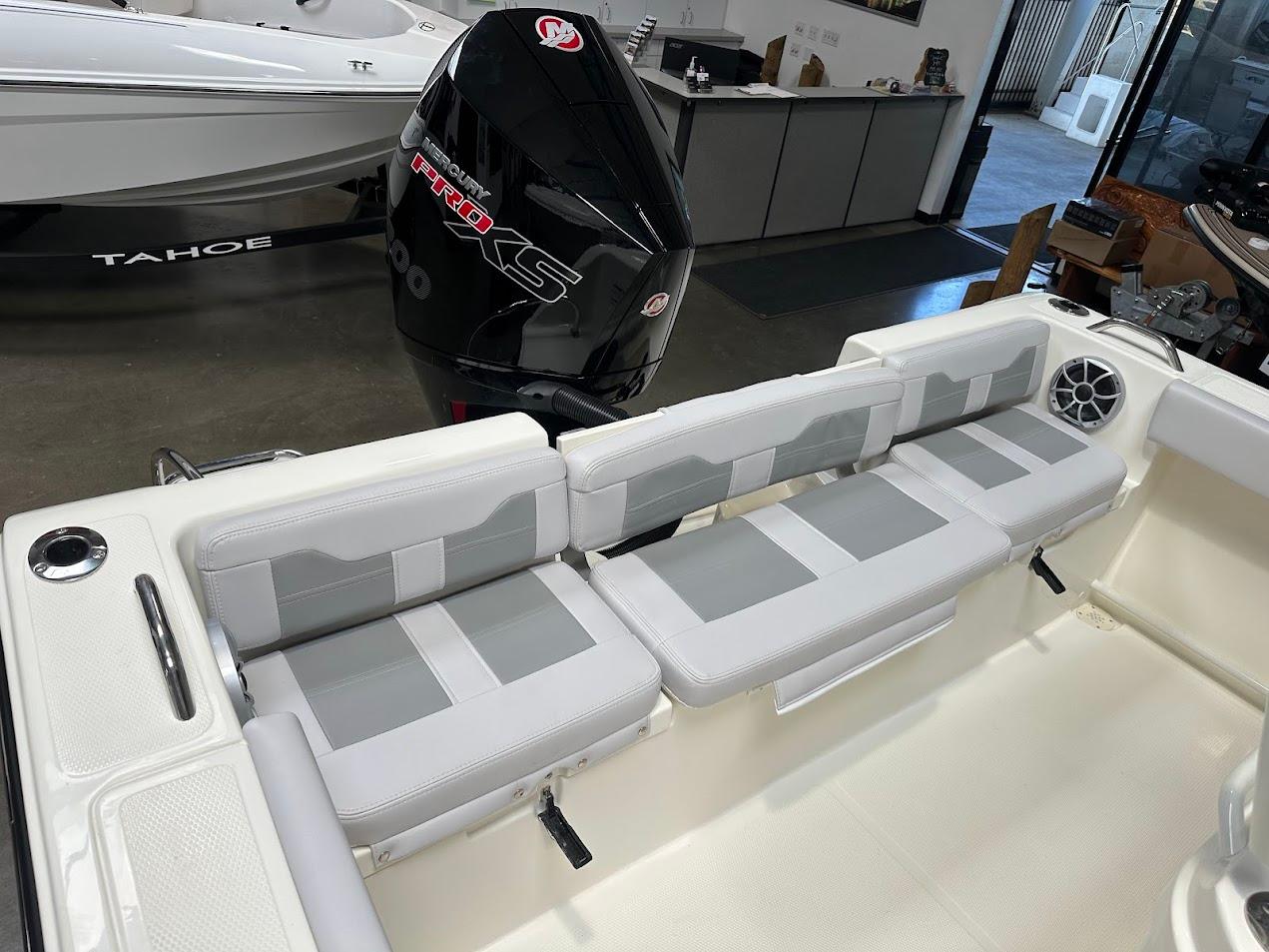 2025 Mako 214 CC boat interior with cushioned seating and Mercury Pro XS engine.