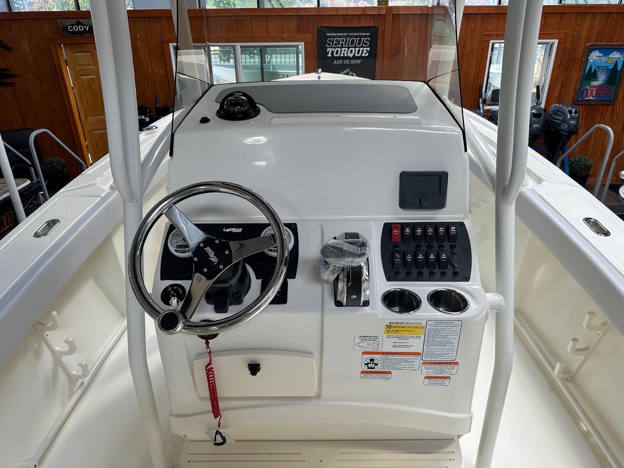 2025 Mako 214 CC boat console with steering wheel and control panel.