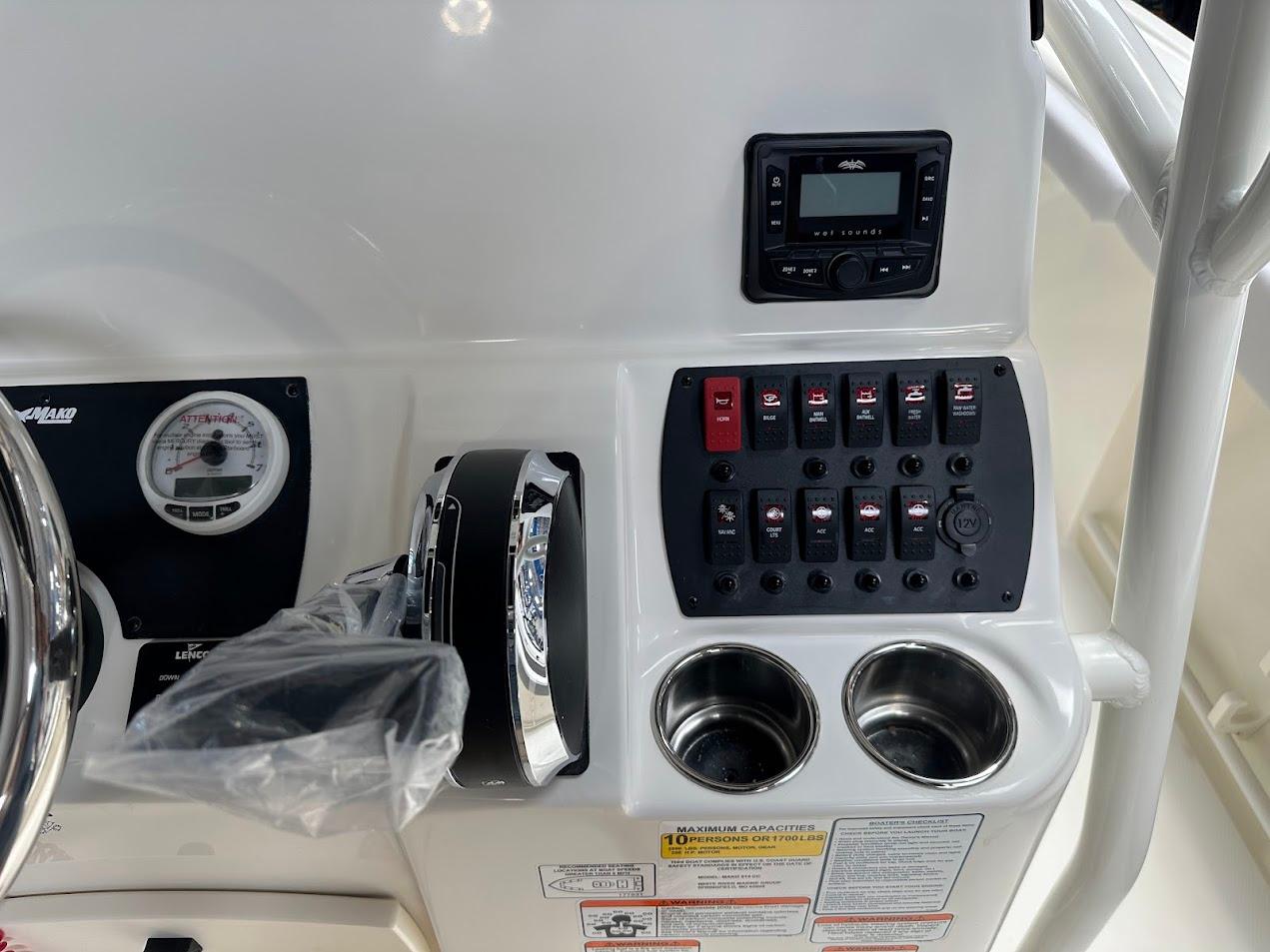 Control panel of 2025 Mako 214 CC boat with switches and gauges.
