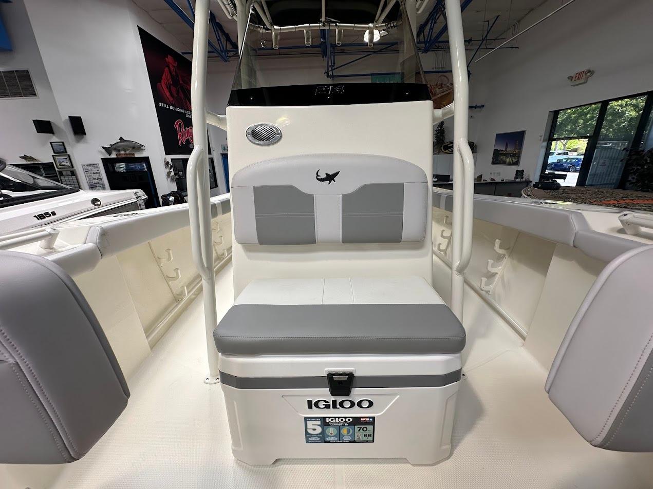 2025 Mako 214 CC boat interior with Igloo cooler seat in showroom.