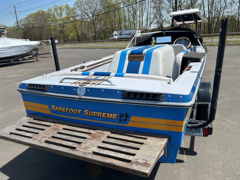1980 Ski Supreme boat, blue and white, parked outdoors with 