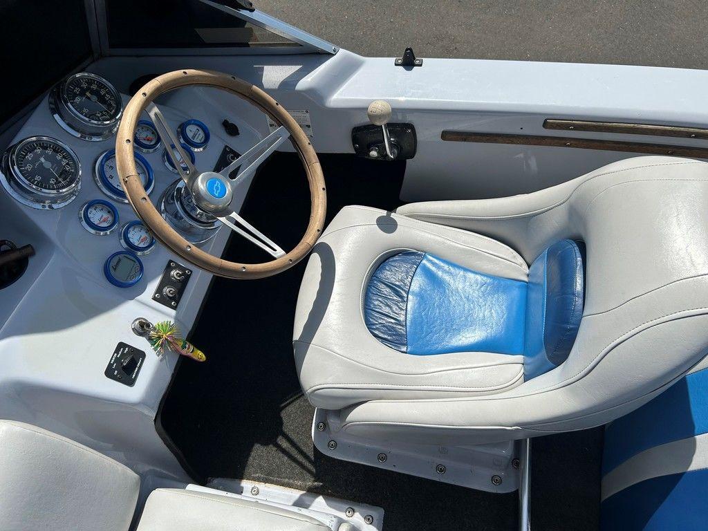 1980 Ski Supreme boat interior with steering wheel, gauges, and white-blue seat.
