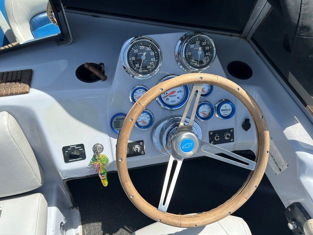 1980 Ski Supreme boat dashboard with wooden steering wheel and vintage gauges.