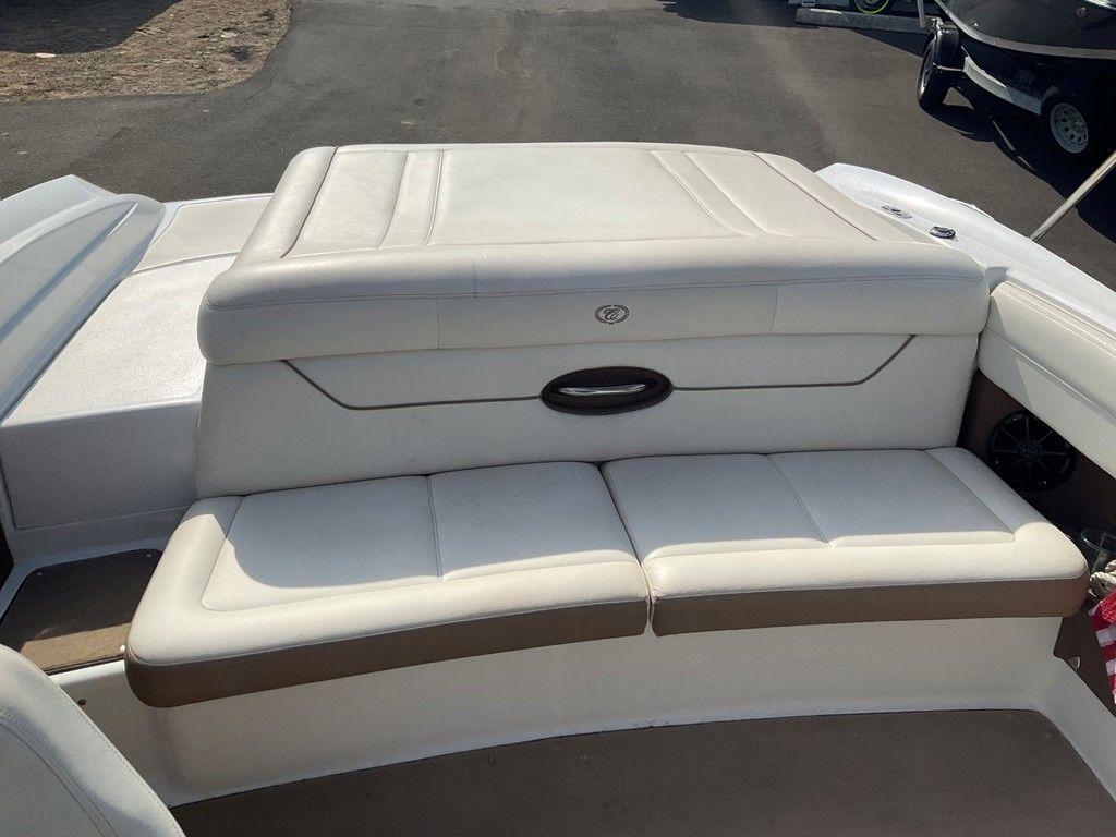 2013 Cobalt 210 boat with white leather seating and storage compartment.