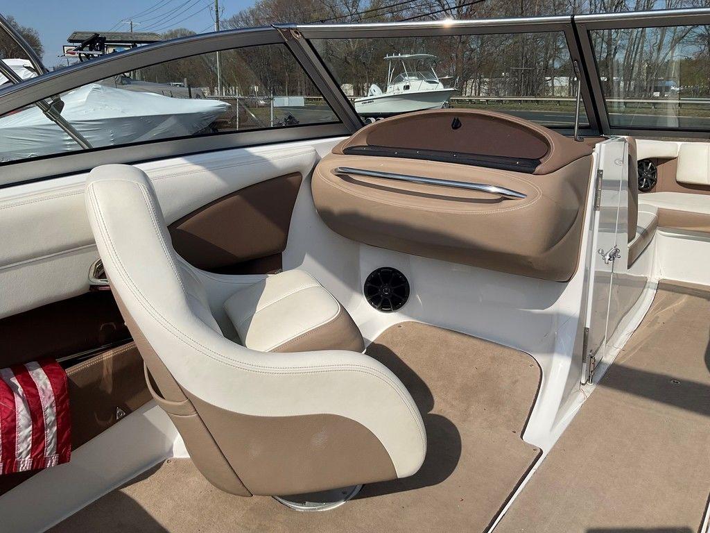 Interior of a 2013 Cobalt 210 boat with beige and white seating.