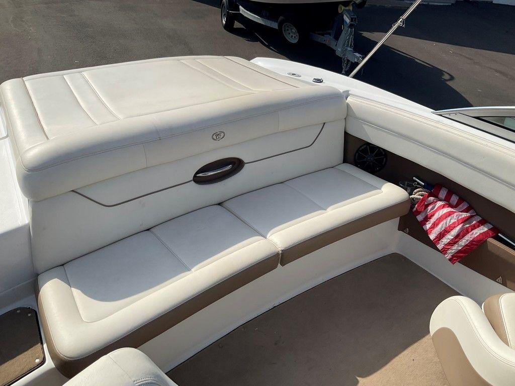 2013 Cobalt 210 boat interior with white leather seating and storage compartment.