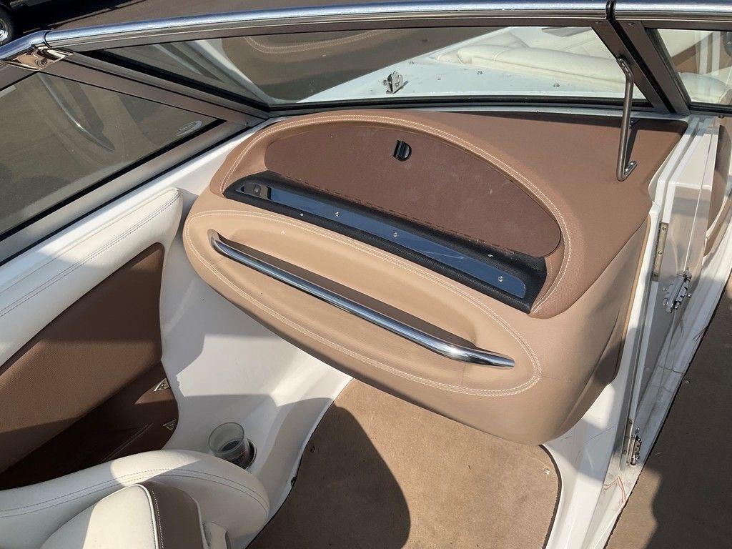 Interior of a 2013 Cobalt 210 boat, featuring beige and brown upholstery.
