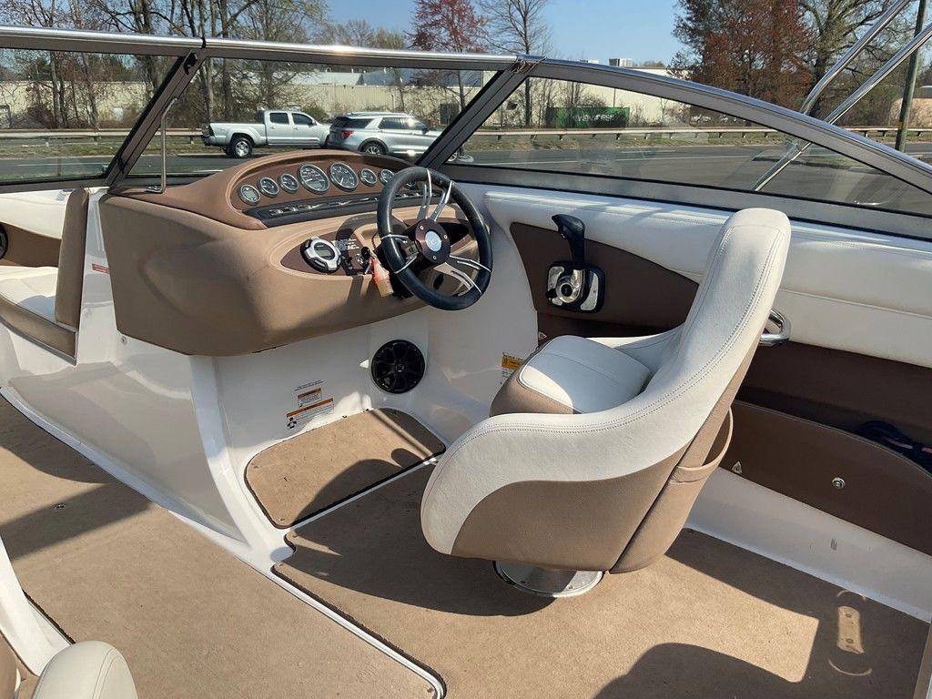 Interior of a 2013 Cobalt 210 boat with beige and white seating.