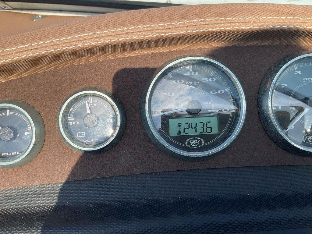 Dashboard of a 2013 Cobalt 210 boat showing speedometer and fuel gauge.