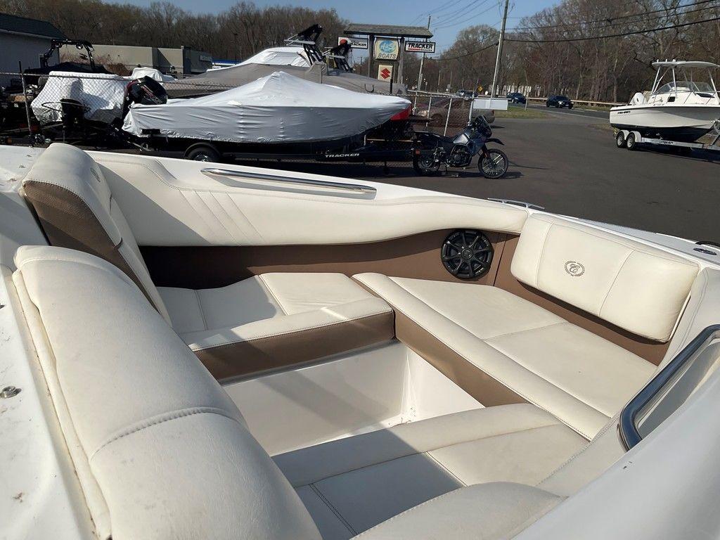 2013 Cobalt 210 boat interior with white and brown seating, parked outdoors.