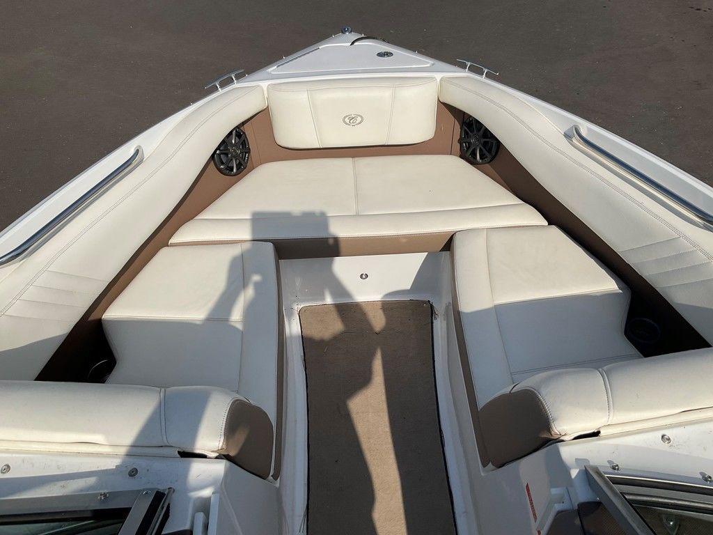 2013 Cobalt 210 boat interior with white cushioned seating and shadow on deck.