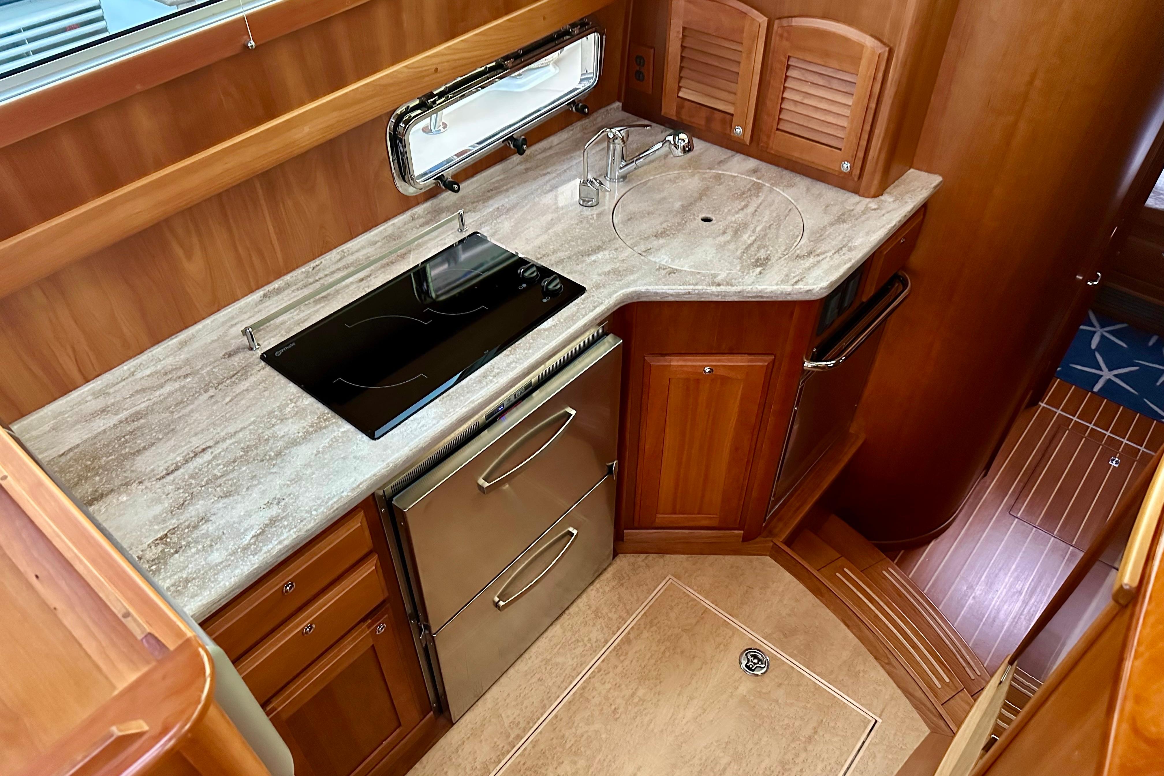 2017 Sabre 42 Salon Express galley with modern appliances and wooden cabinetry.
